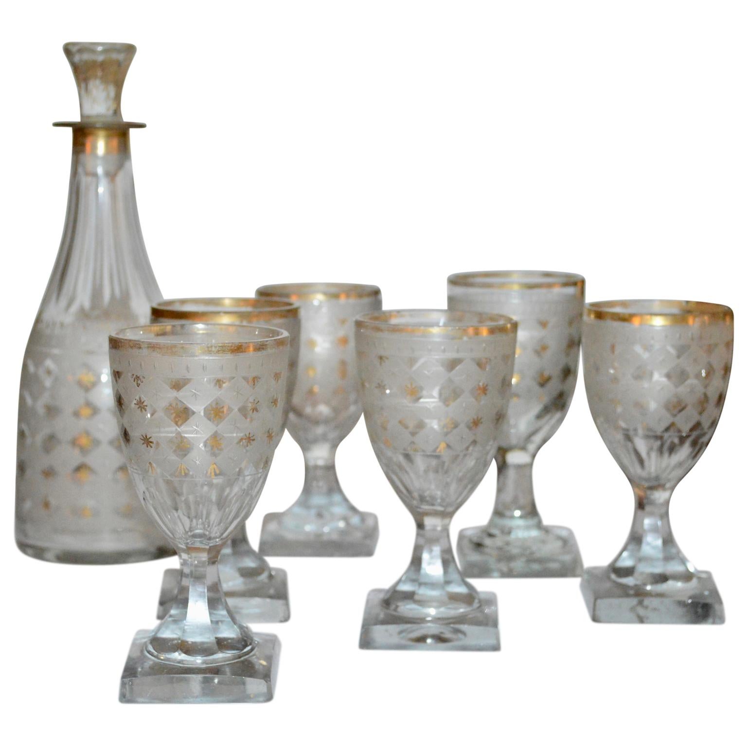 Late 18th century Harlequin pattern decanter and 6 small glasses

Decanter and glasses are decorated with golden edge and stars.