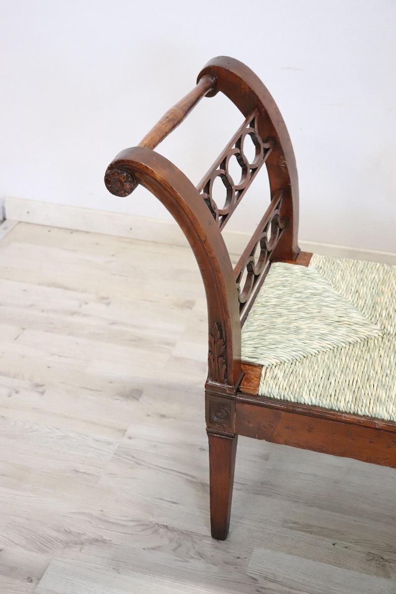 This exquisite Italian antique bench, crafted in the late 18th century during the Louis XVI era, embodies the elegance and simplicity characteristic of this historical period. Its design features linear legs complemented by wavy outer arms, joined