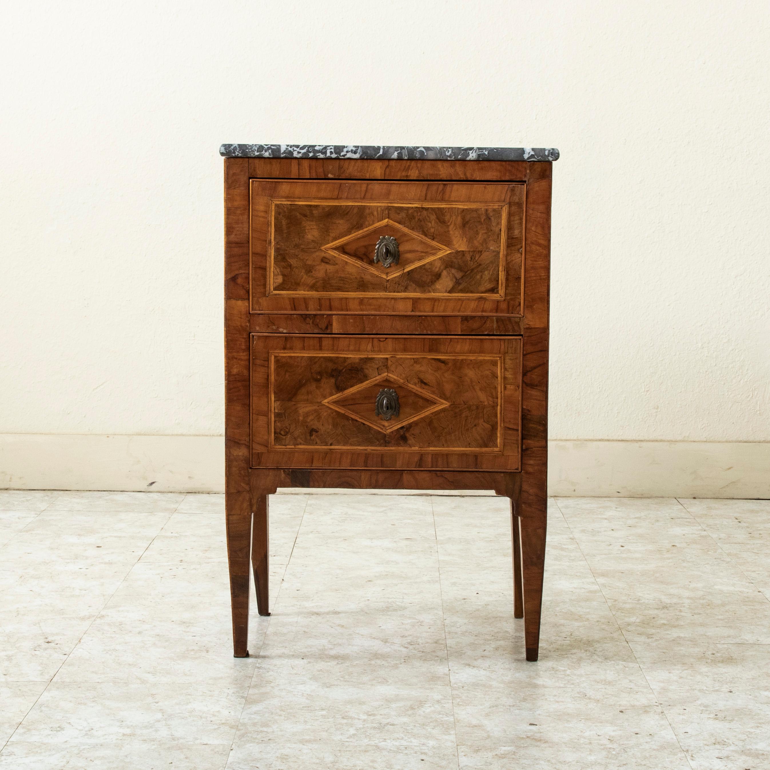 This late eighteenth century Italian walnut marquetry chest or nightstand features inset borders on three sides of fine lines of lemonwood. A central diamond lozenge details each side and drawer front. Two drawers of dovetail construction are fitted