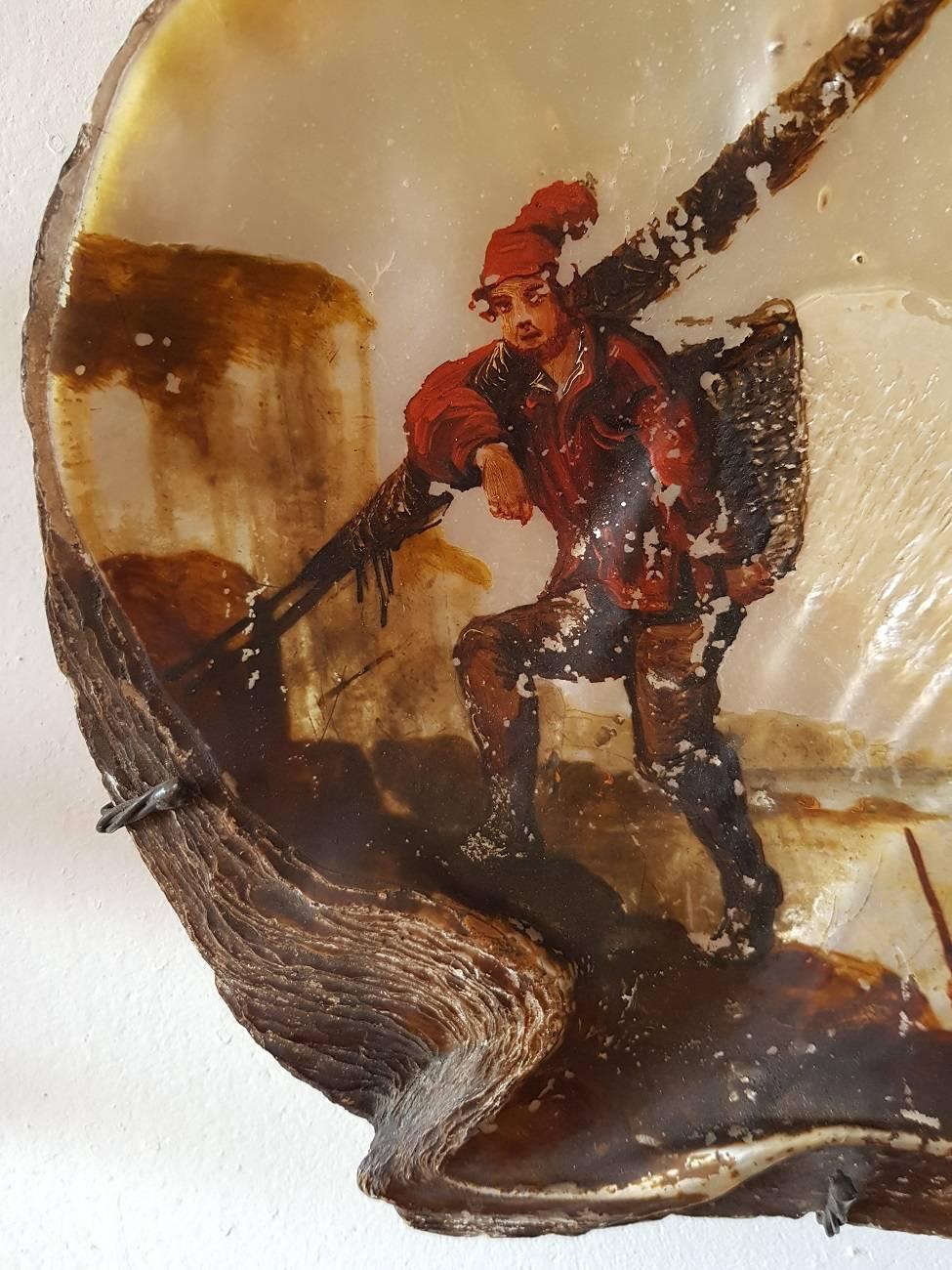 Late 18th century Italian painted oyster depicting two fishermen on the coast. It has some paint loss and is signed at the bottom right but unclear.

The measurements are,
Depth 2.5 cm/ 0.9 inch.
Width 22.5 cm/ 8.8 inch.
Height 21.5 cm/ 8.4