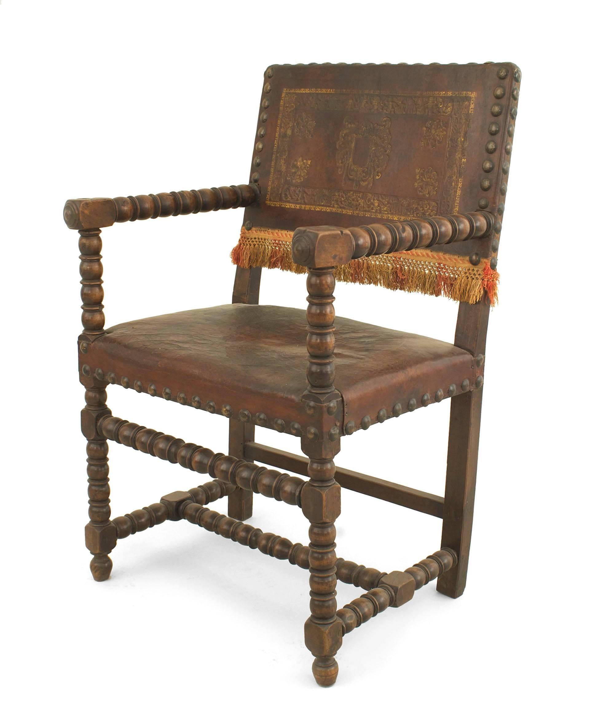 Italian Renaissance style (18/19th Cent) walnut arm chair with spool design on arms and stretcher with a brown leather seat and embossed design on back.

