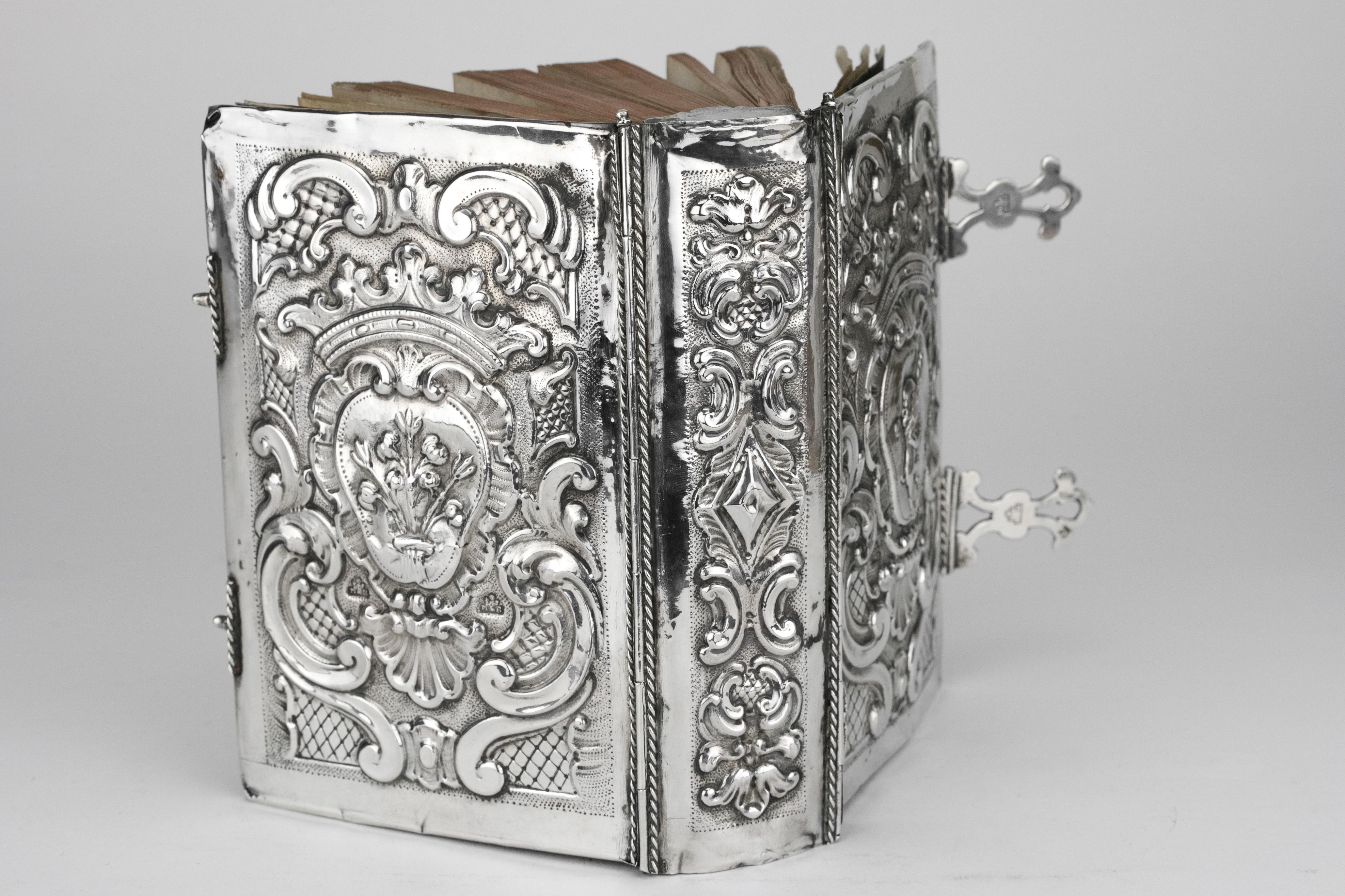 Handmade Italian silver book binding, maker's mark MB with figure holding emblems between for Marc'antonio Belotto of Padua, 1776-1788.
Both covers embossed with coats of arms in baroque cartouches under coronets on matted and trellis grounds, the