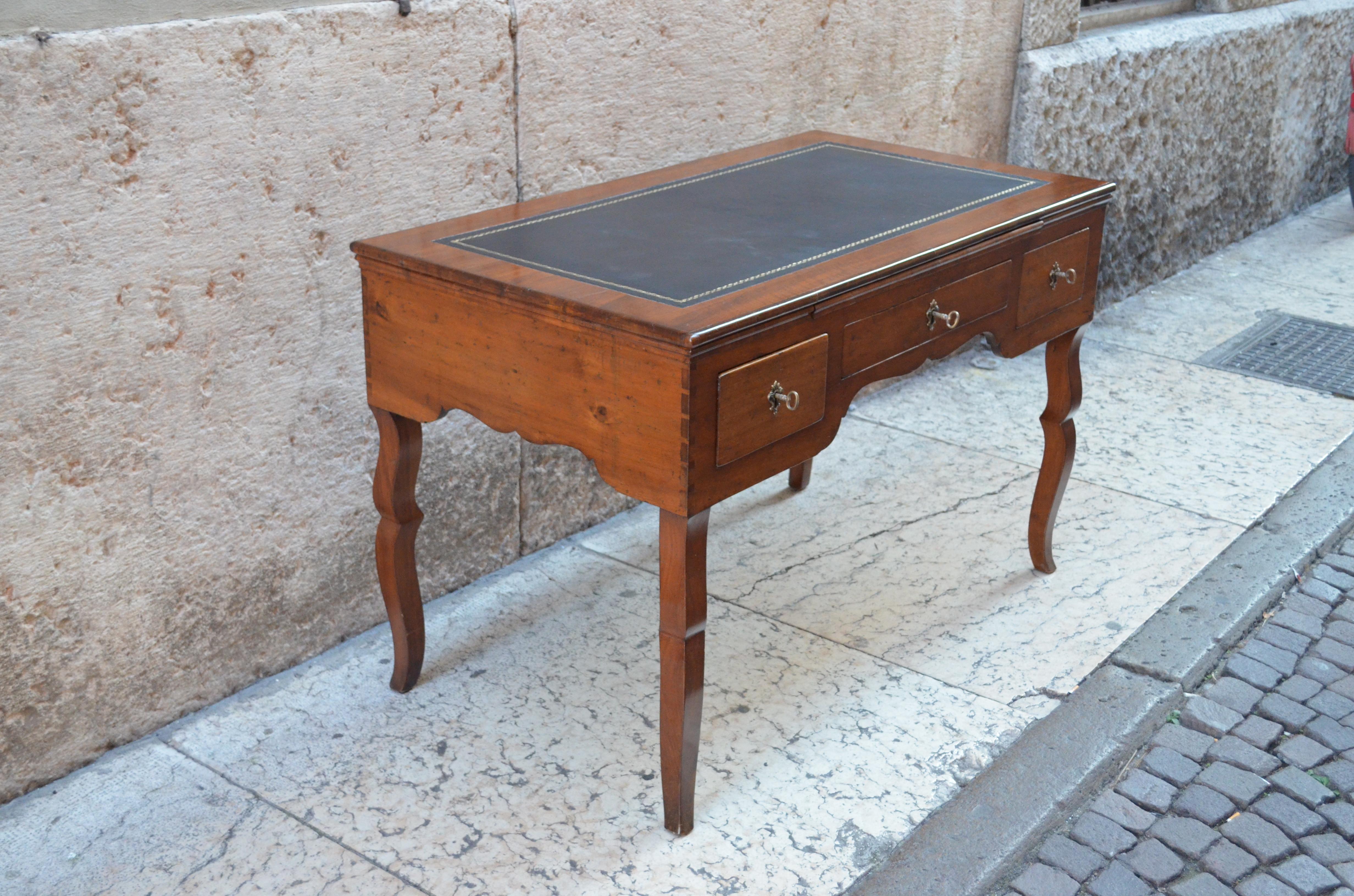 Italian walnut wood desk from late 18th century. Take a look at the legs of this desk which are incredibly shaped. The desk as three drawers. There is a tray to extend the writing surface. Original hardware and lockers. Still present and visible the
