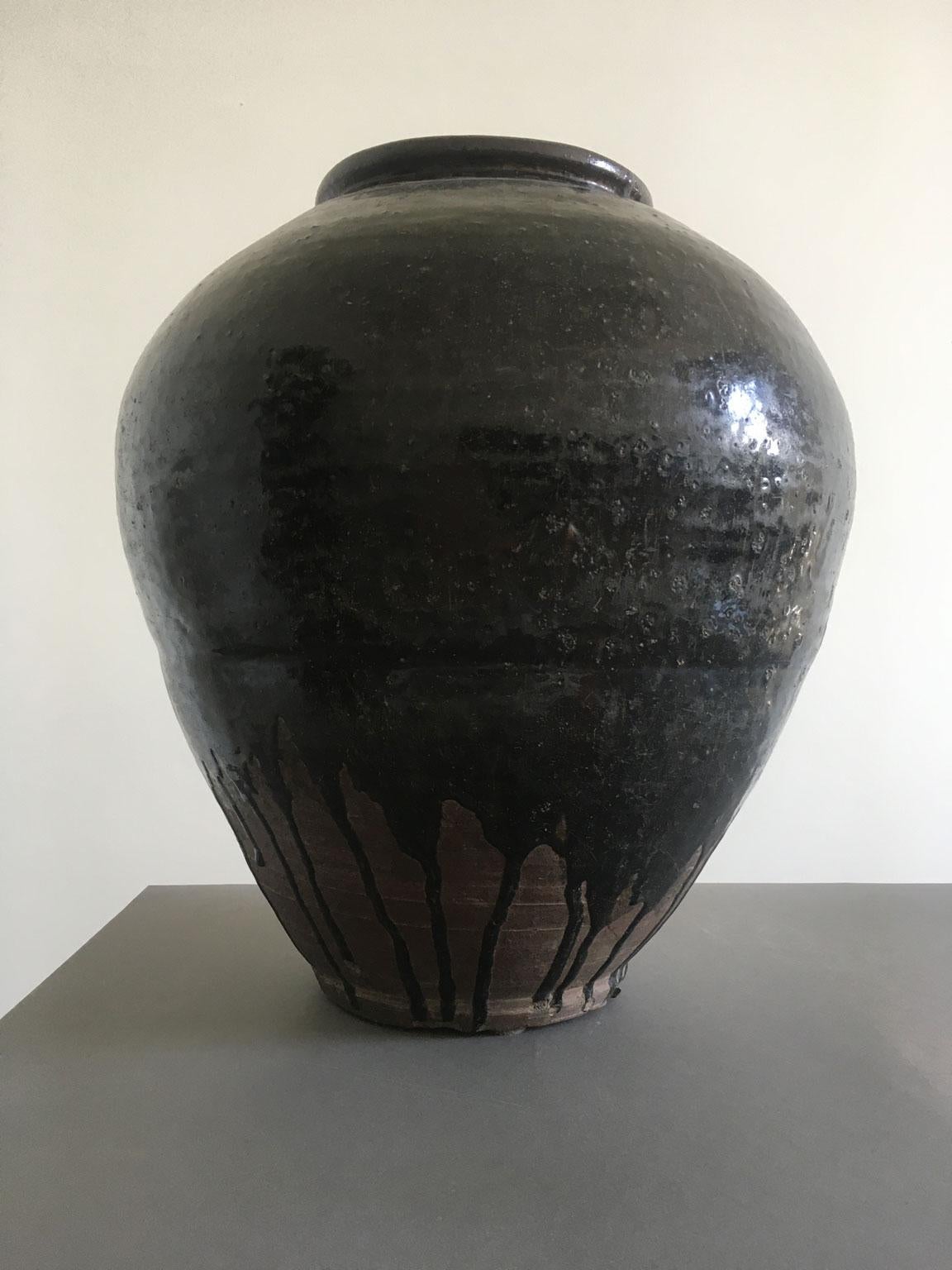 This Khmer brown glazed terracotta vase is a very stunning piece with its organic shape and all the signs of the time.
The enameled surface well shows its period and for this reasons the piece is an eye catching in every room.
It is not easy to find