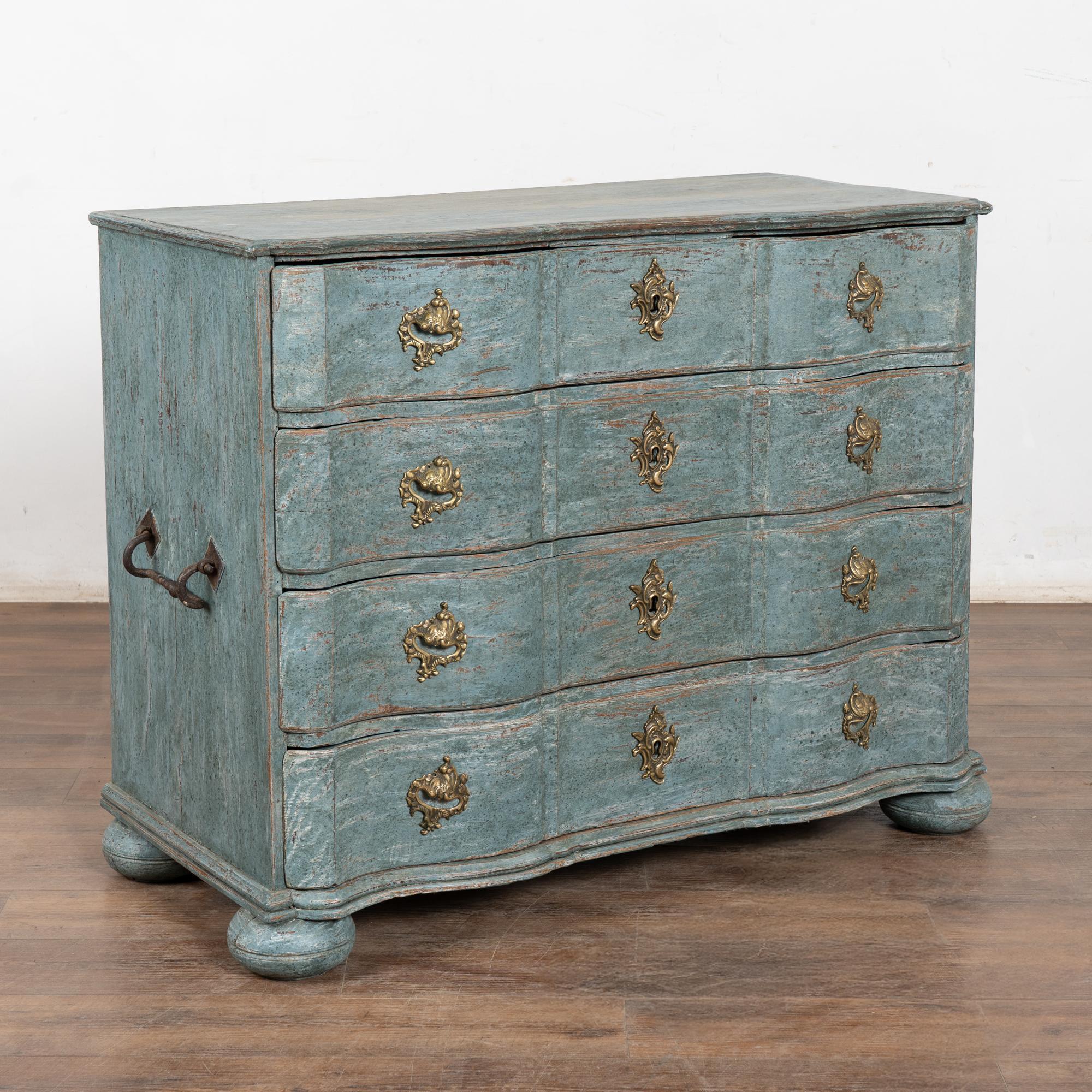 Cette grande commode ancienne de style rococo présente une façade serpentine, de jolies poignées en laiton et repose sur de grands pieds en chignon.
Elle a reçu une exceptionnelle nouvelle finition peinte en couches bleues professionnelles (avec des