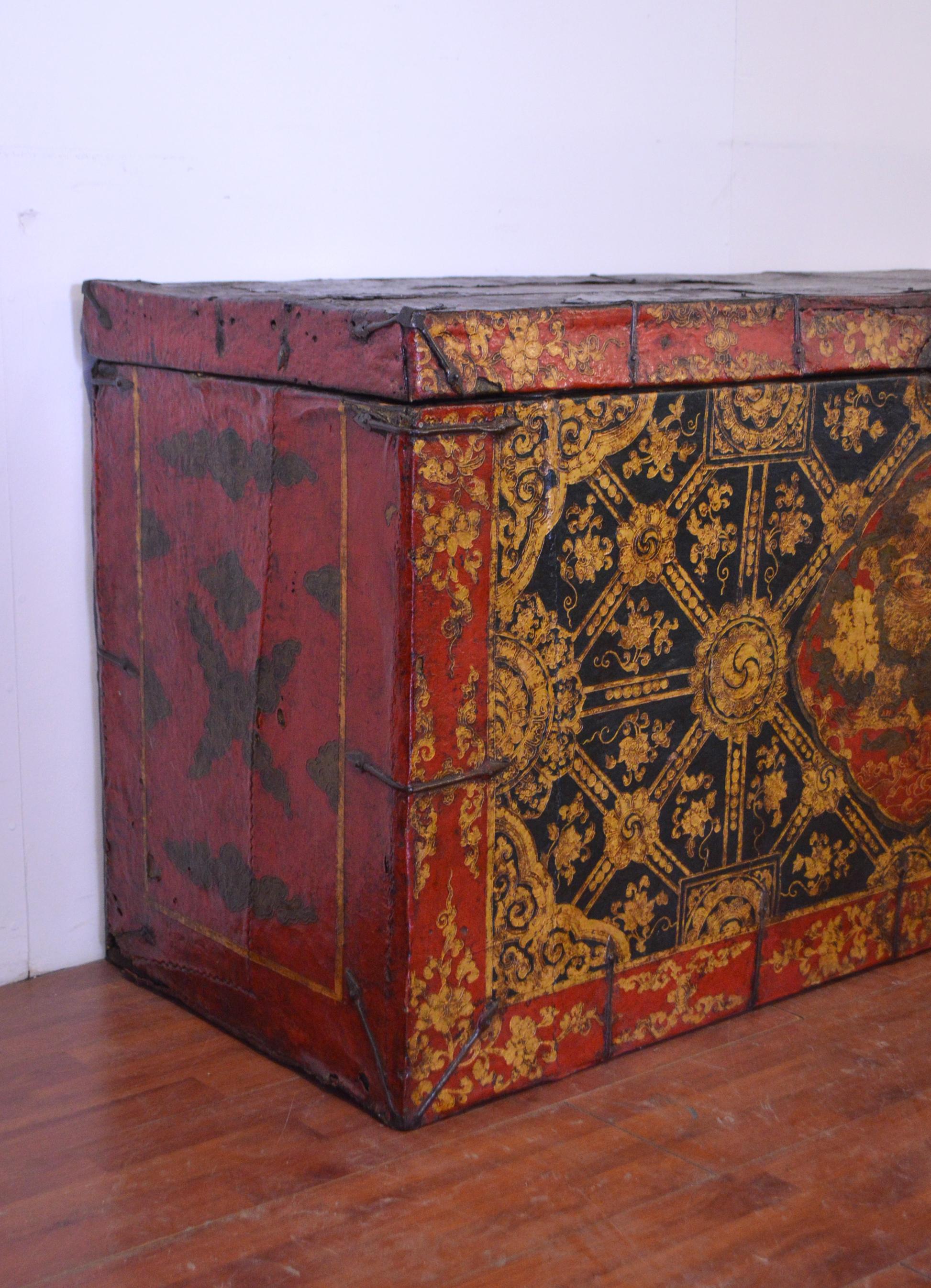 This late 18th century Tibetan trunk is absolutely exclusive and unique. Its surface is totally leather-covered and with some metal reinforcements that we can always find in these kind of furniture.
In the middle is clearly visible the picture of a