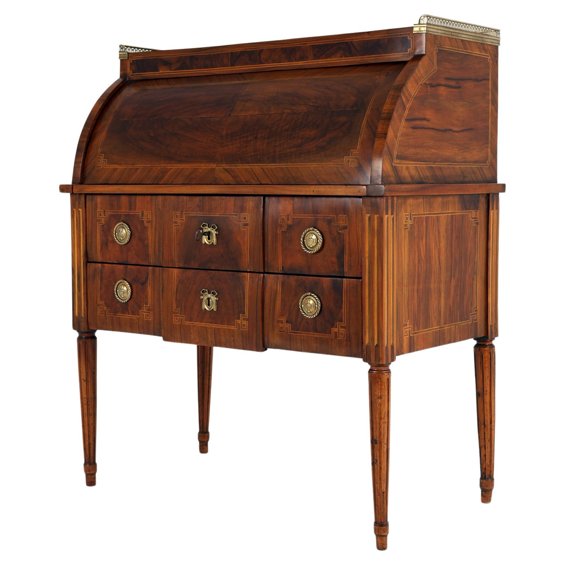 Late 18th Century Cylinder Desk with beautiful Patina,
1800, France

Cylinder desk with straight sides, closed in the upper part with a semi-circular flap, with two drawers. The whole rests on angular legs, richly veneered with with beautiful walnut