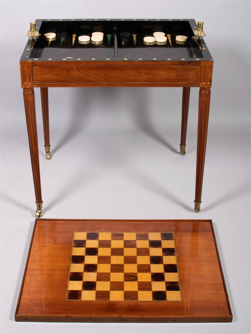 Late 18th century Louis XVI Mahogany and Marquetry Inlaid Tric-Trac games table. Rectangular reversible mold top opens to reveal inlaid game boards in a conforming frieze on turned tapering fluted legs with brass cap feet Measures: 29