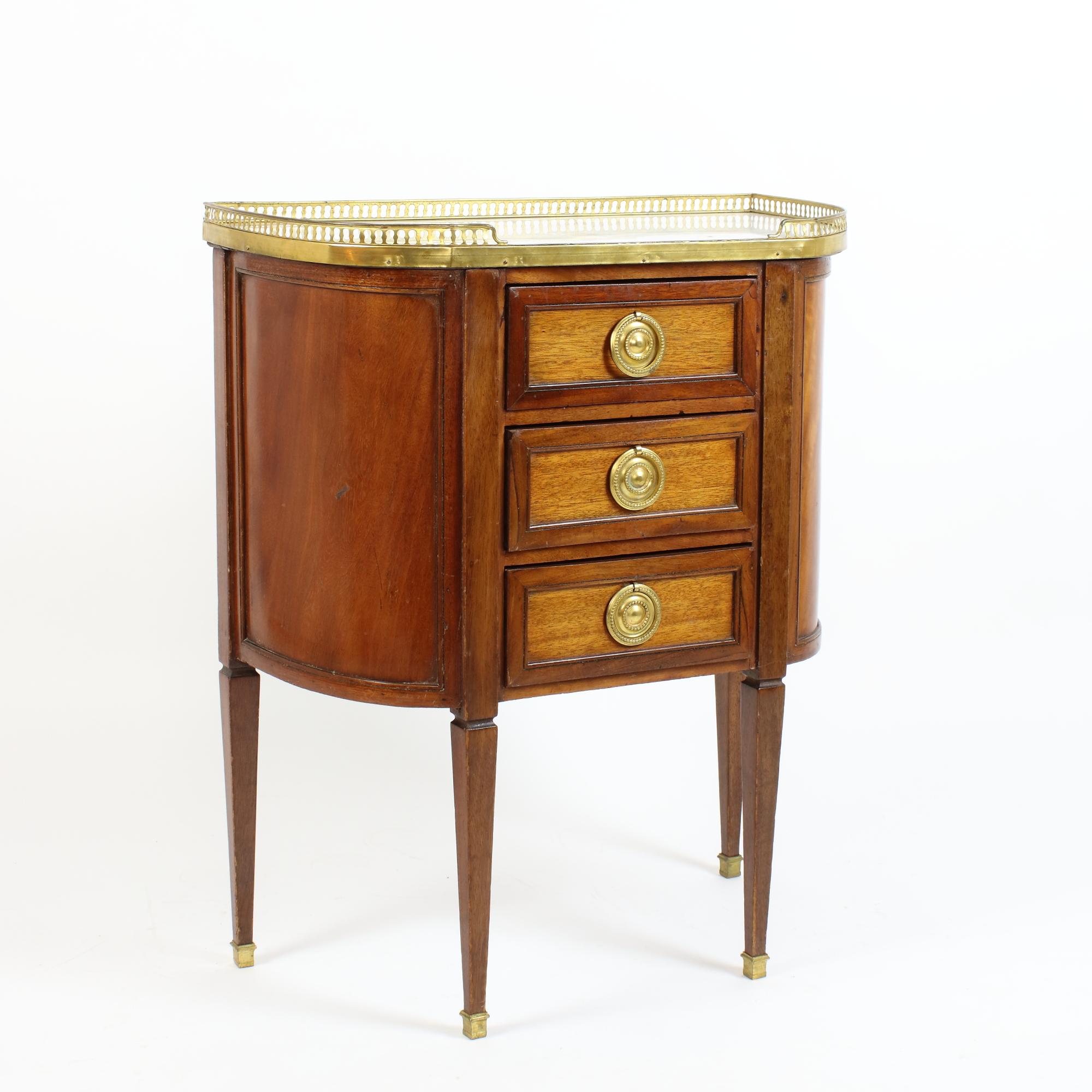 Late 18th Century Louis XVI walnut demilune commode or table chiffonière

A demilune or semi-ellyptical commode with a straight front and curved sides: The commode is raised by four tapering rectangular legs with gilt-bronze sabots and opens with