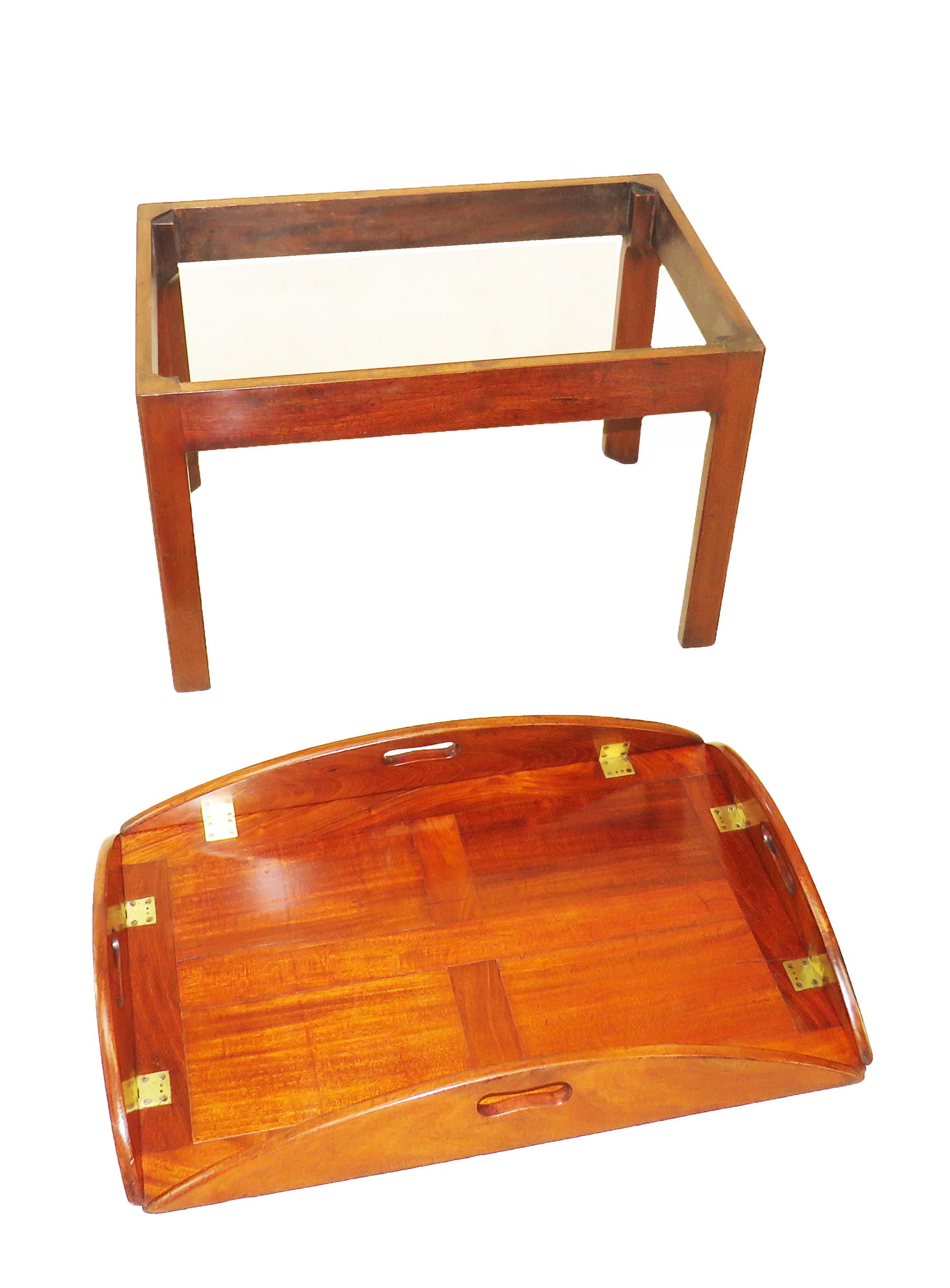 A good quality late 18th century mahogany
Oval butlers tray having well figured panels
And original brass hinges to folding sides
Housed on later mahogany square
Chamfered leg stand

(Always a great solution to the age old
problem of there