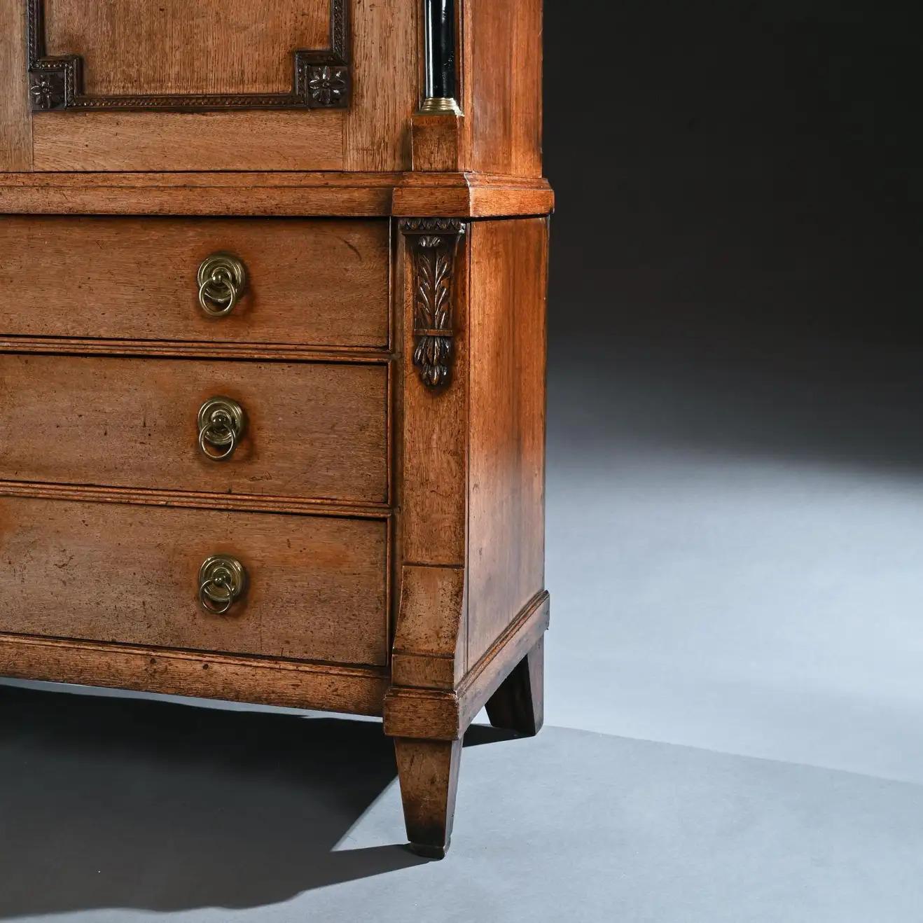 An imposing late 18th century Dutch oak linen press of wonderful natural faded oak color.
Dutch circa 1790
Of substantial proportions, constructed throughout with oak pegs, topped by a beautifully hand carved dentil-moulded segmental pediment,