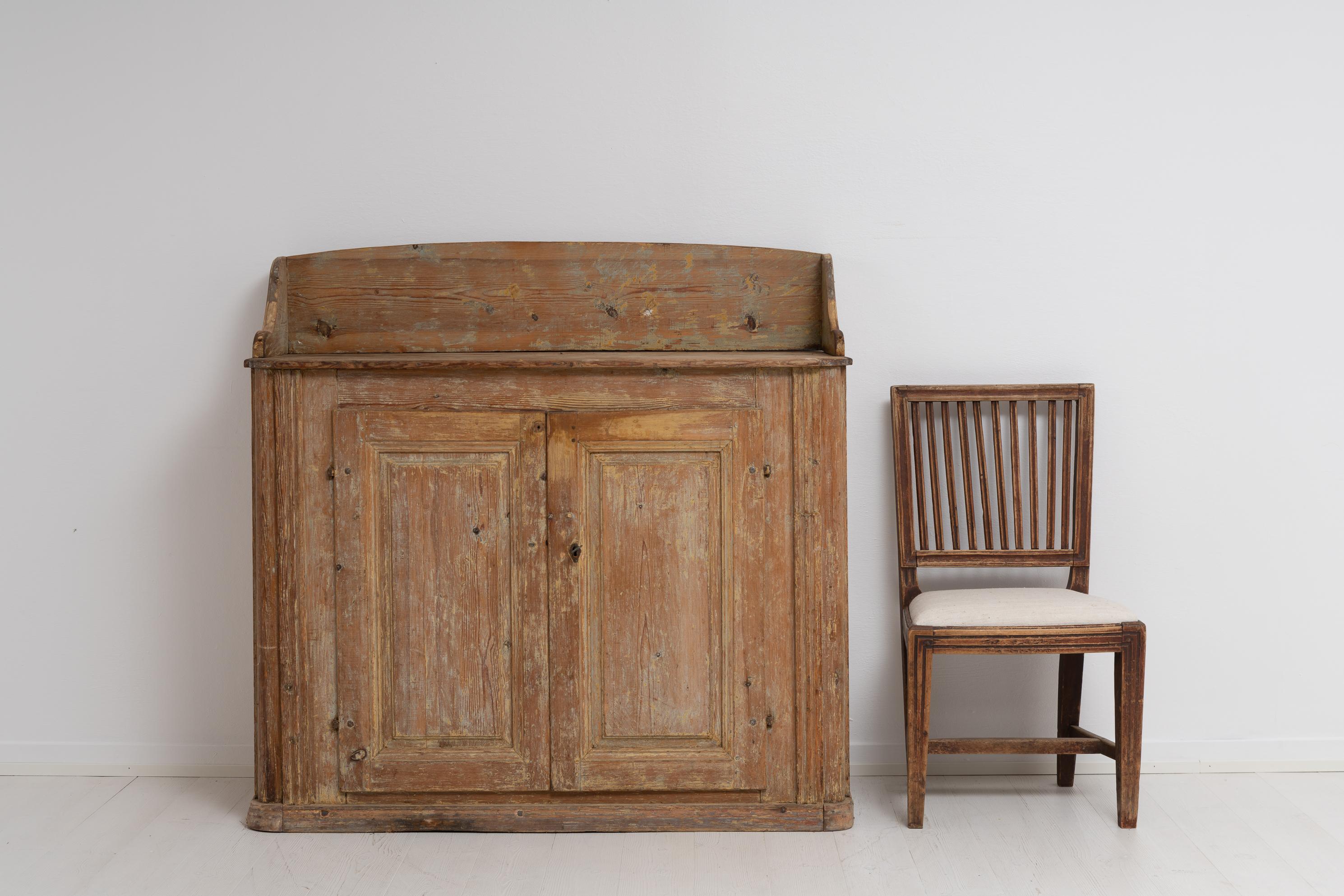 Northern Swedish late 18th century country house rococo sideboard. The sideboard is pine with traces of the original paint. Worn and distressed surface with characterful patina after 250 years of use. Healthy and solid frame. Minor marks and traces