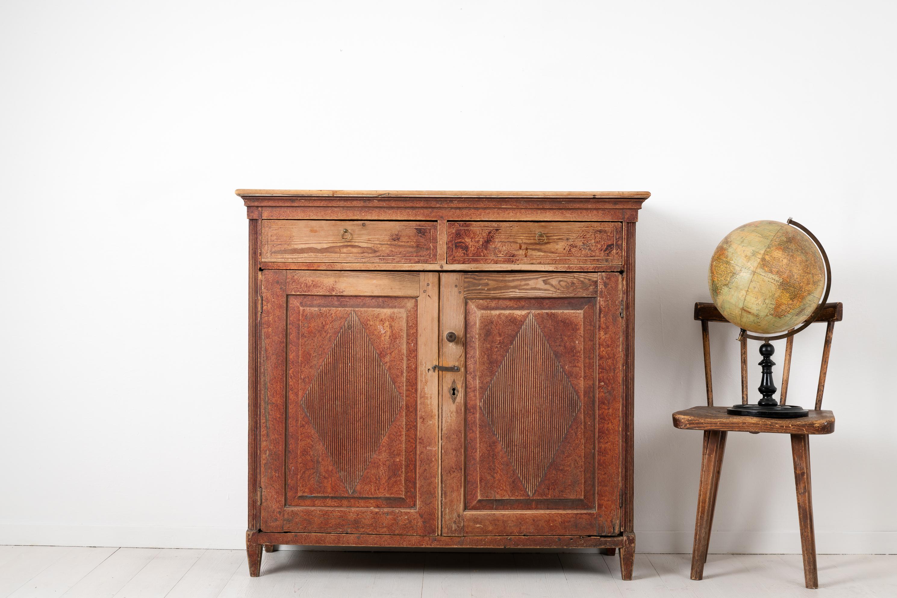 Gustavian sideboard from northern Sweden made during the late 18th century, around 1790 to 1800. The sideboard has the original paint with genuine distress and authentic patina. The paint is faux paint which imitates the appearance of other