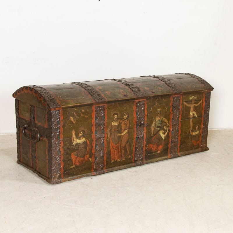 This amazing domed top oak trunk from Denmark is a rare find. The original dark paint remains along with the date of 1797(seen on the top). Unique to this chest is the four figural panels which each portray the Passion of Christ, from praying in the