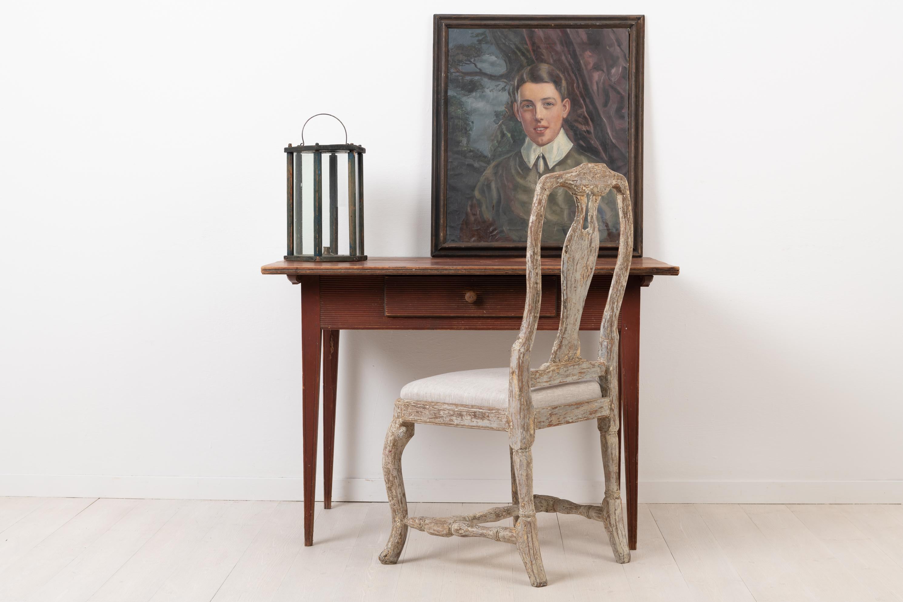 Neoclassical desk from northern Sweden. The desk or table is in pine and from circa 1790. Original condition. Original and distressed paint from the late 1700s with marks of wear, see pictures. The desk is decorated with a horizontal ribbed decor