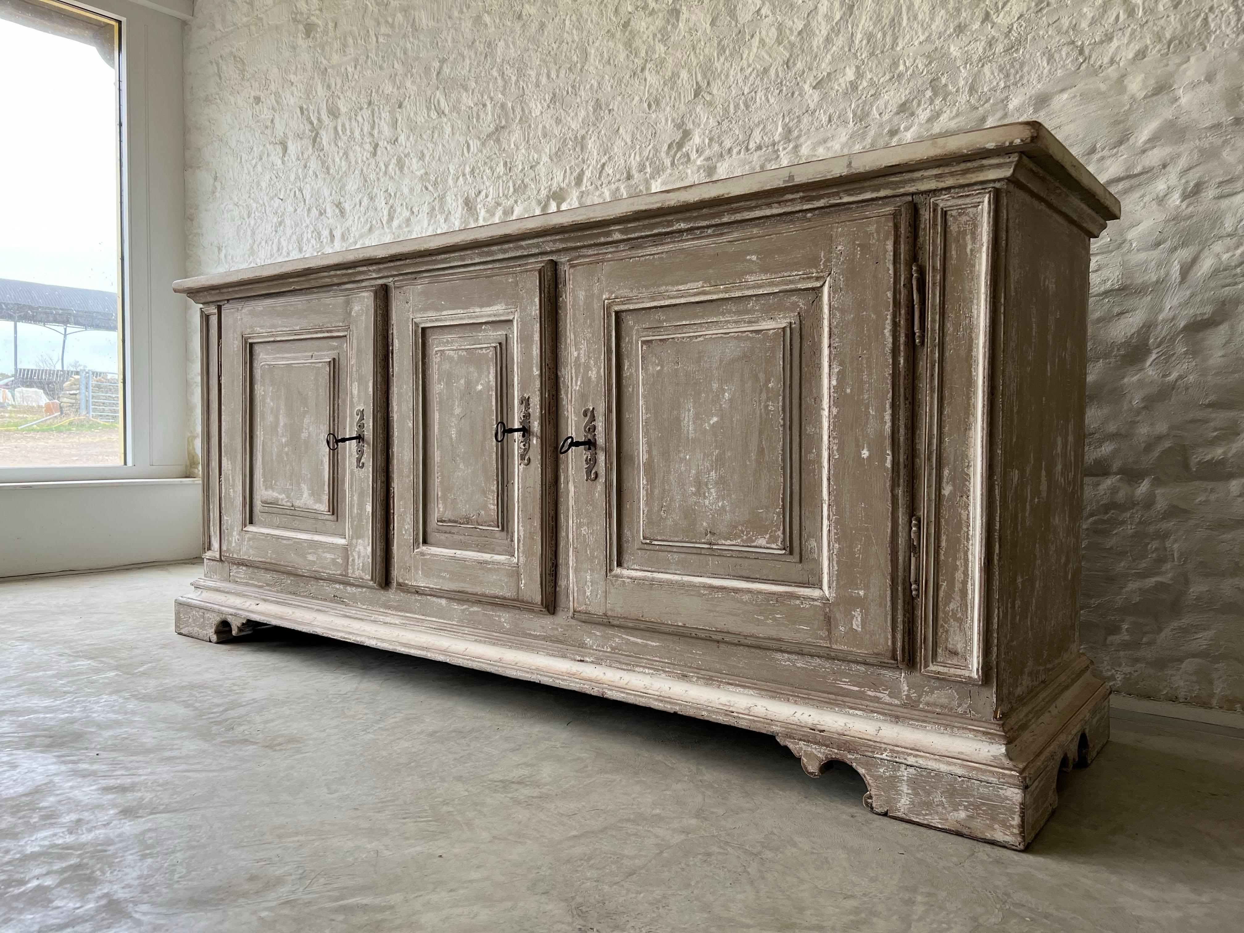 Sourced in Northern Italy this beautiful sideboard is Late 18th Century.

Although hard to tell, we believe that it has been expertly repainted and knocked back producing this lovely patina.

Made from oak and pine it is in great structural