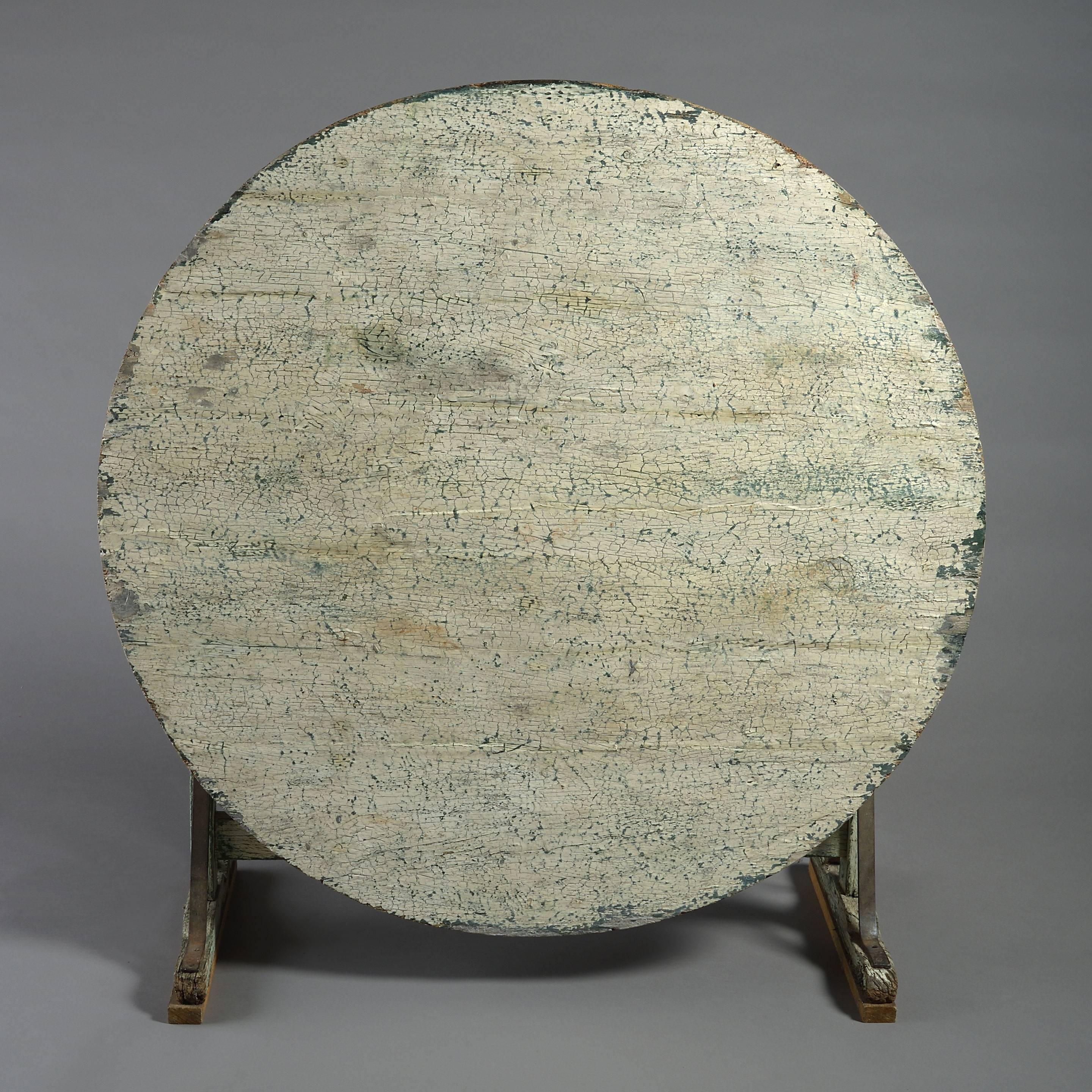 A late 18th century white and green painted wine table, the hinged oval top supported upon a gate leg base.
