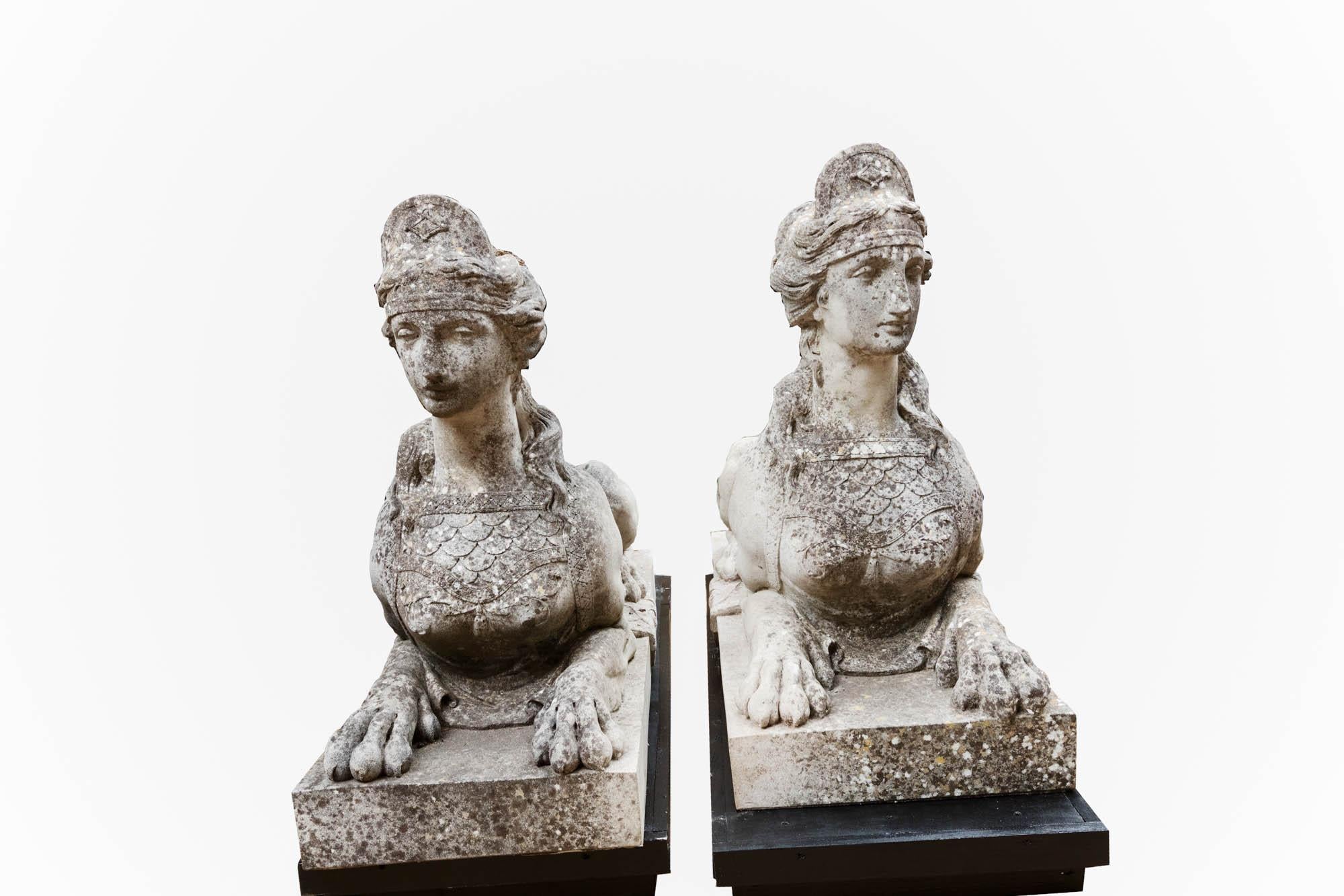 Late 18th century pair ‘Coade Stone’ sphinx figures designed by sculptor William Croggon. This fine pair are adorned with small tiaras, and are composed of female torsos with lion-like bodies covered by embroidered saddlecloths. The pair rest on