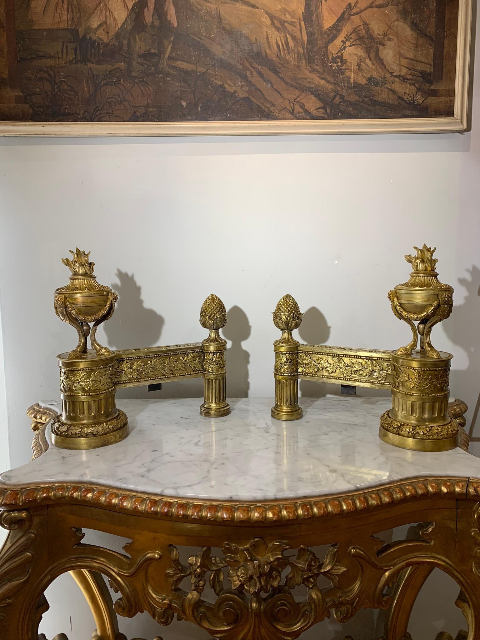 Pair of neoclassical andirons of rare beauty, in lost wax cast bronze, finely chiselled and gilded. Dating back to the end of the 18th century (ca. 1790), they were made with extreme skill by skilled Italian craftsmen. The influence of the