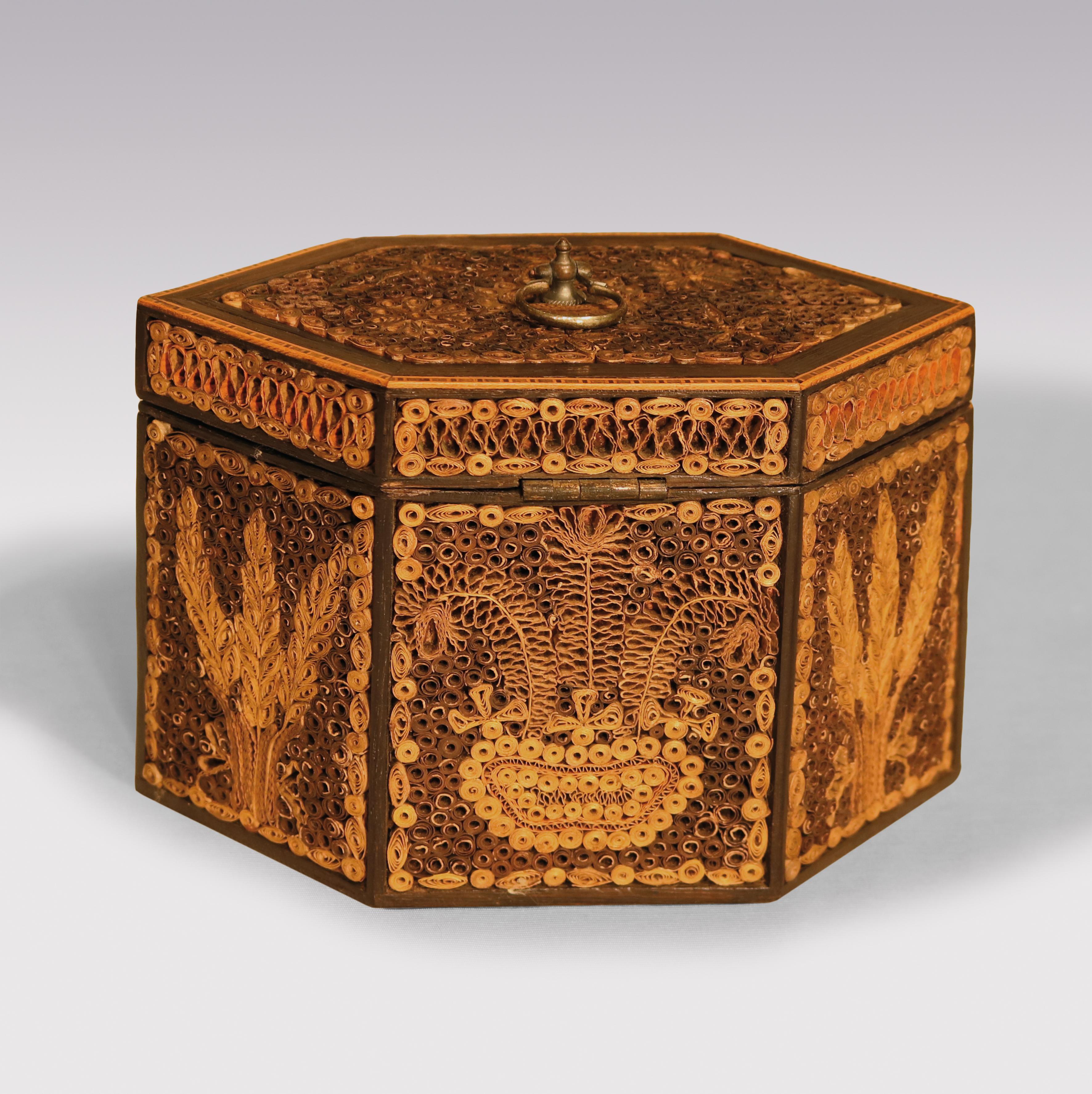 A fine late 18th century octagonal paper scrollwork tea caddy decorated with vases of flowers and trees, retaining bright gilt detail.