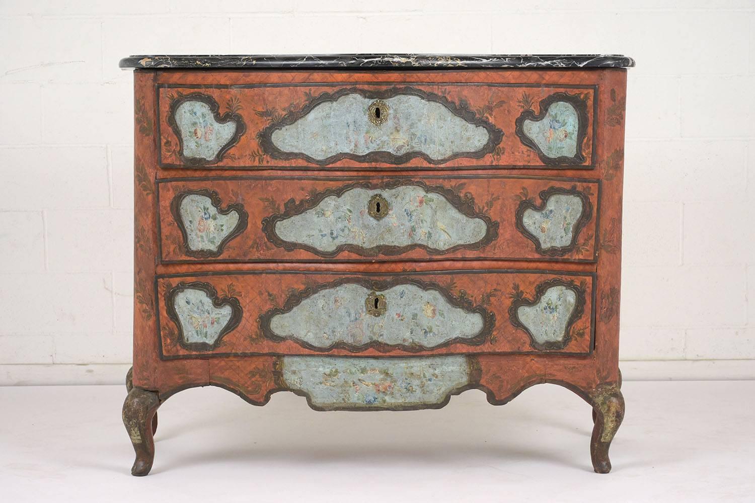 This stunning Sicilian chest of drawers dates to the late 1700s and is in remarkable condition. The chest is painted a rust orange color with a textured finish and leafy details. Adorning the sides and front are organic shaped accents of light blue