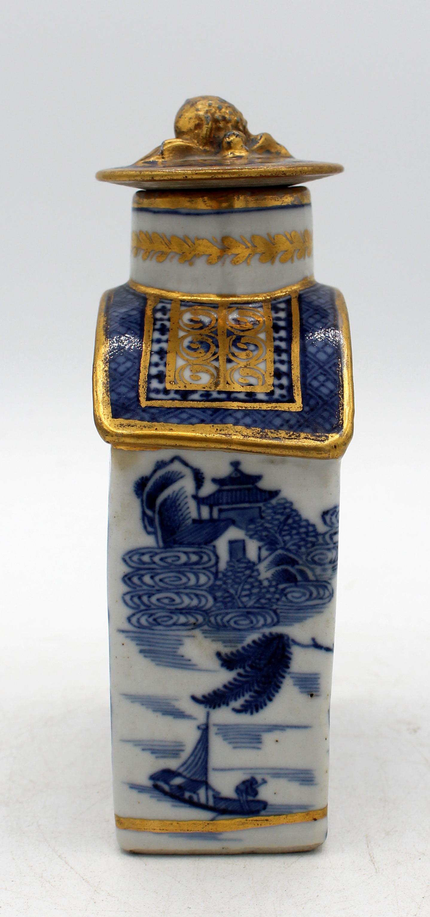 Late 18th century blue & white tea caddy with cover, Chinese. Porcelain. Qing Dynasty. All sides with tea houses, lakes & boats. Elegant gilding, likely French. The apparently original cover repeats the blue underglaze decoration & the gilding.