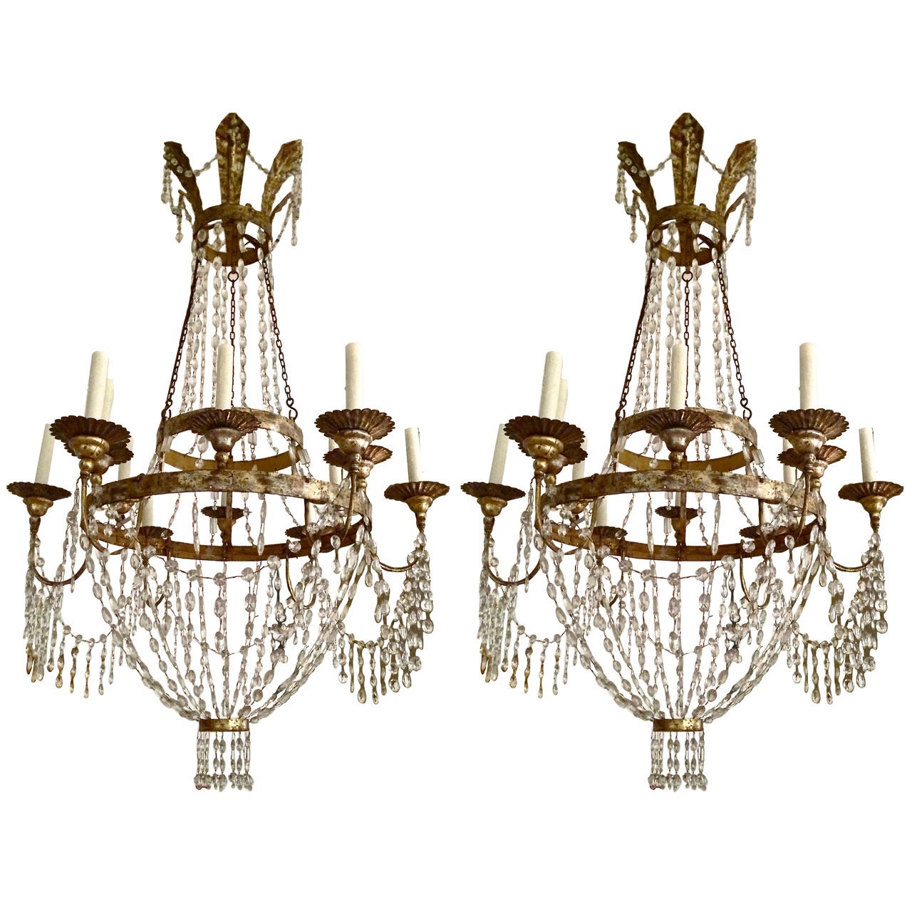 Italian empire cut glass mounted silvered metal twelve-light chandelier.

Main annulus supporting two rows of tiered light arms joined by faceted swags and joined to upper rings by swags, surmounted by six scrolled leaf corona.

Neoclassical