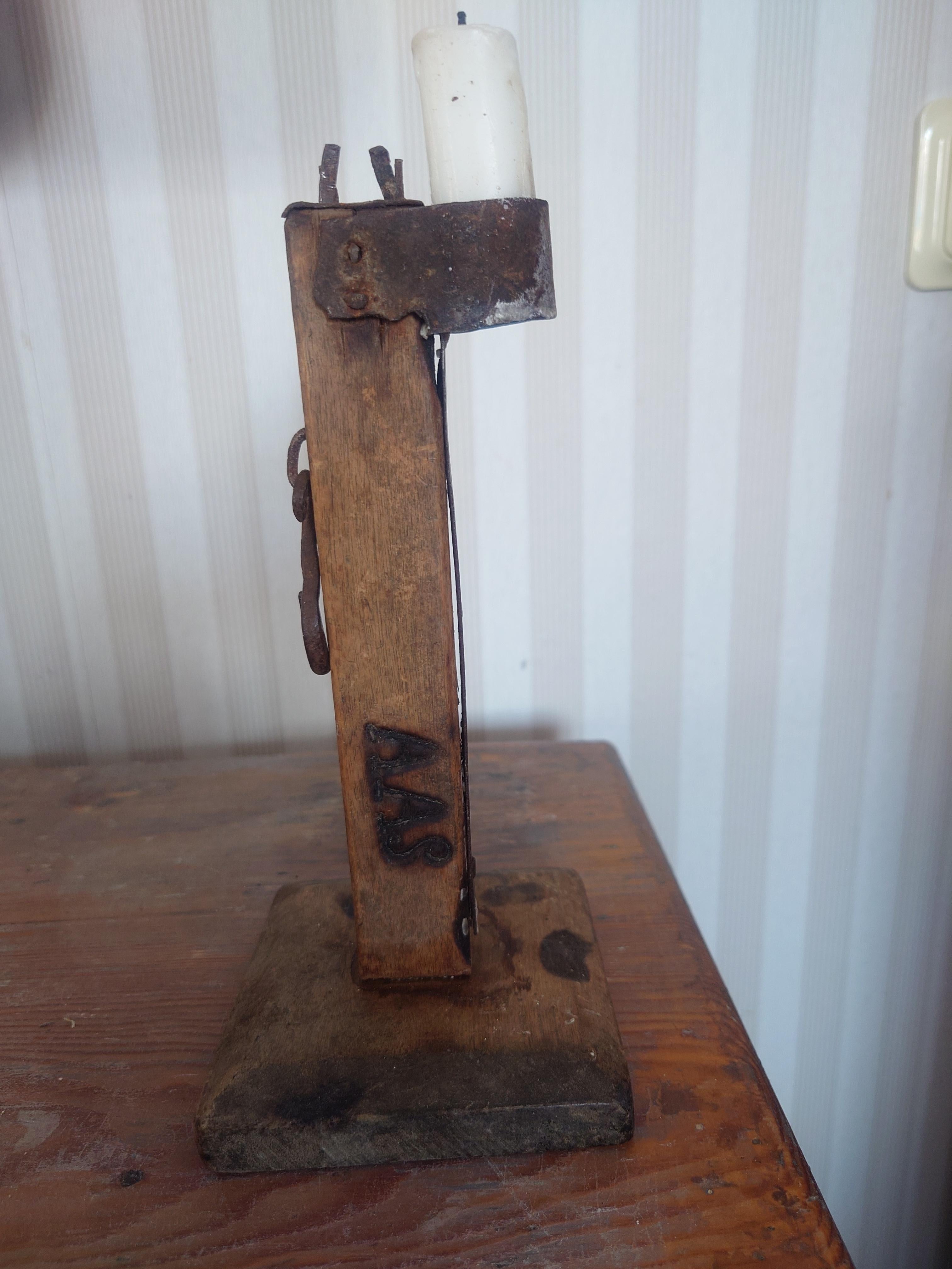 An old antique swedish 18th century iron & wooden  candlestick .
The candle stick has a owner mark AAS.
Very charming and solid.
The candlestick is called 