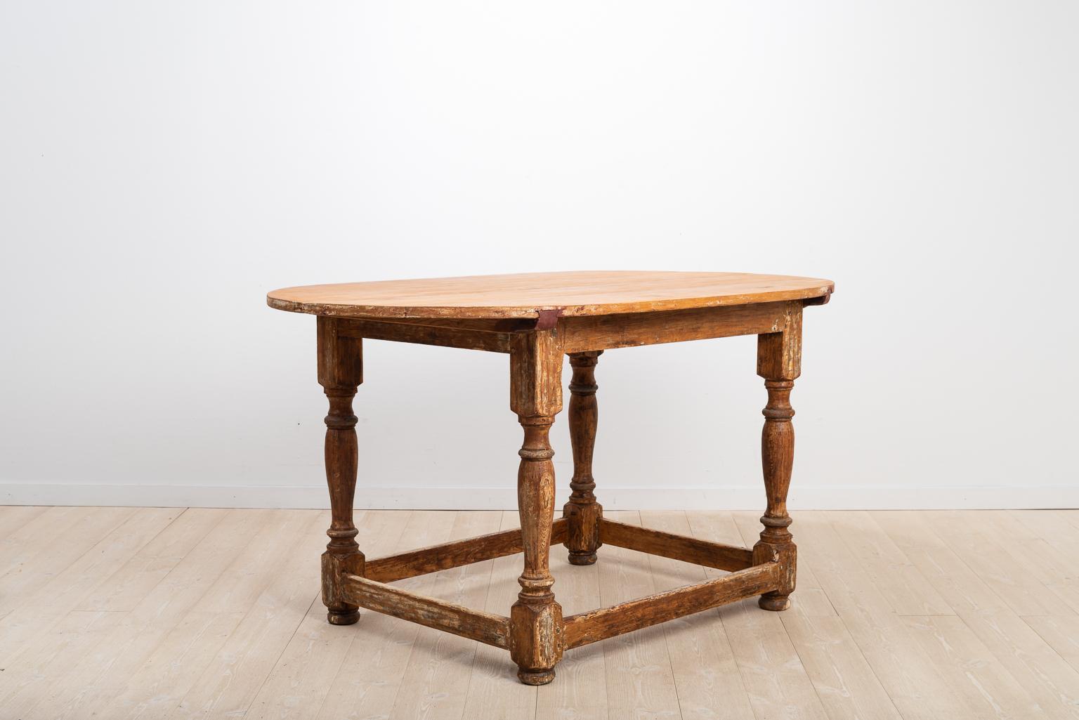 Antique Swedish baroque centre table in pine. The table is originally from northern Sweden and has wonderful proportions with the four turned legs and a sizeable table top. A monogram is branded on the underside of the table. Mostly likely the