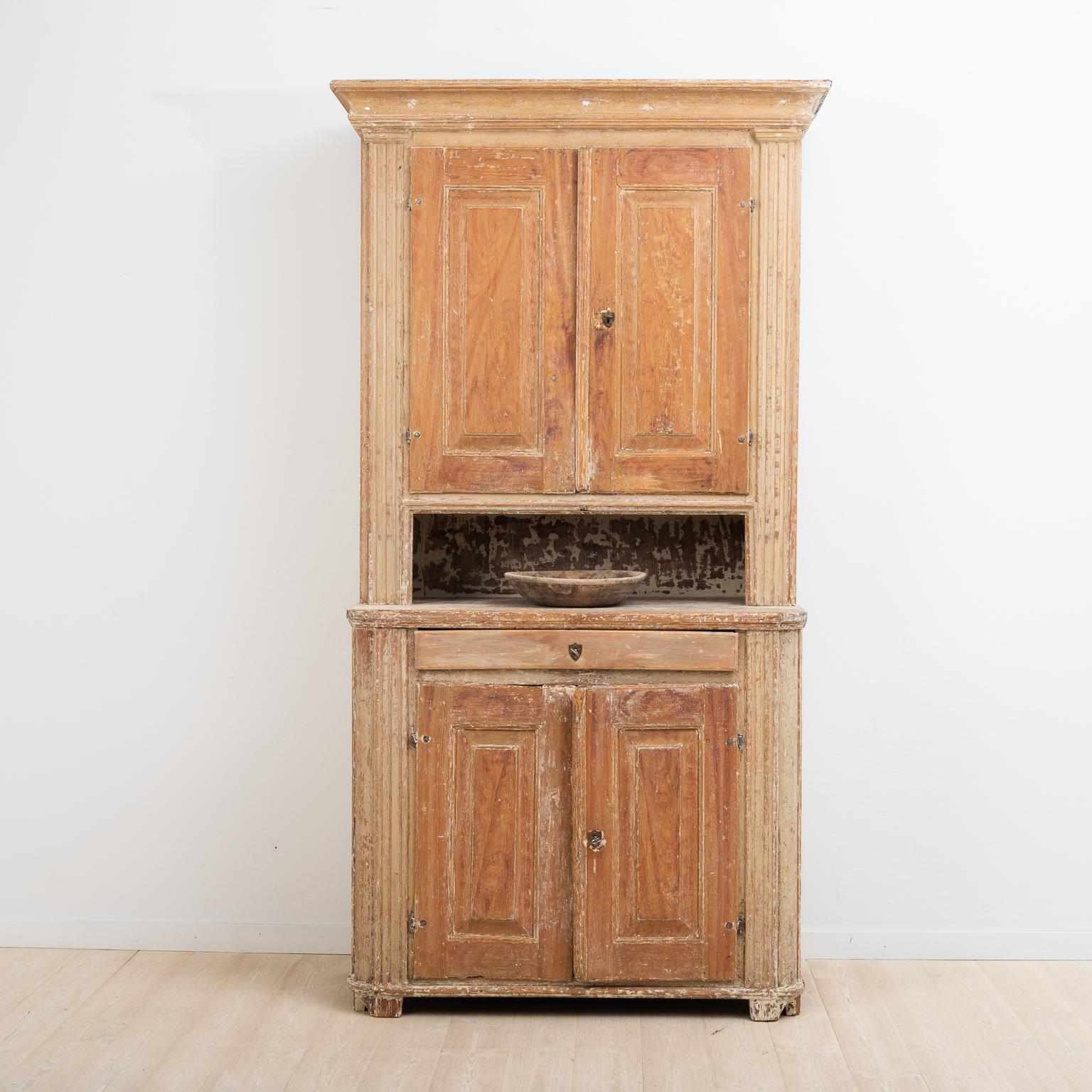 Late 18th century Swedish Gustavian cabinet. The lock and key are original and in working condition. The surface is scraped to original paint and has a rustic patina.

One part has been used as a bedside cabinet. As a compact living furniture it