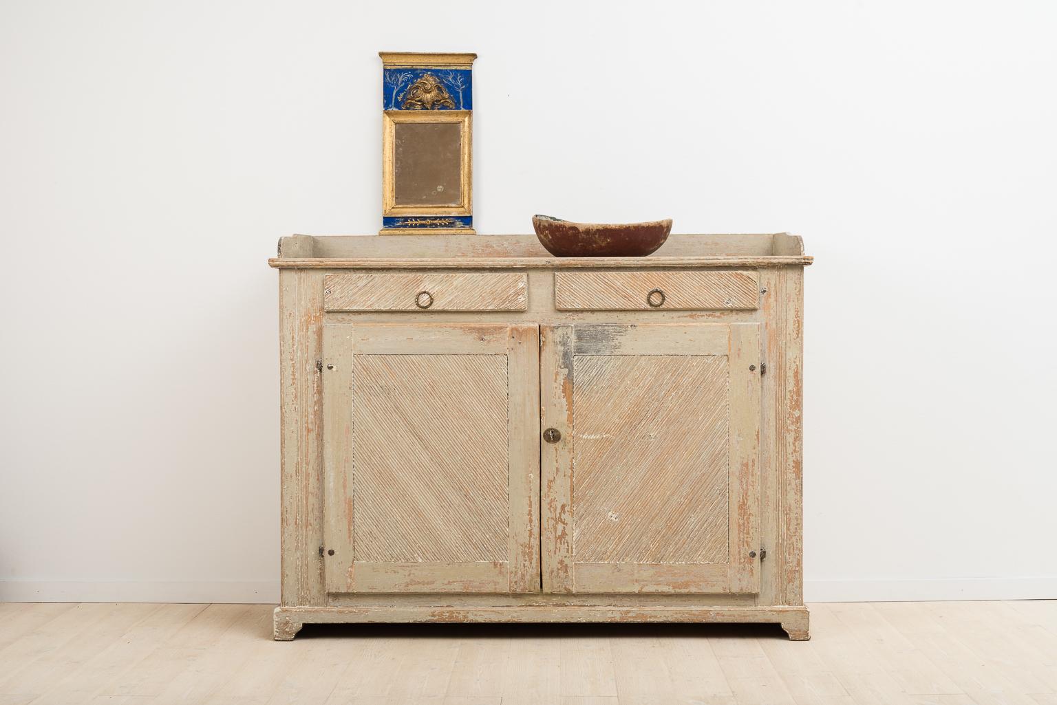 Gustavian sideboard from northern Sweden that’s been dry scraped to original paint. Originates from an old farmhouse located in a small village called Stöde in northern Sweden. It is rare to find sideboards this long and low. Working lock and key,