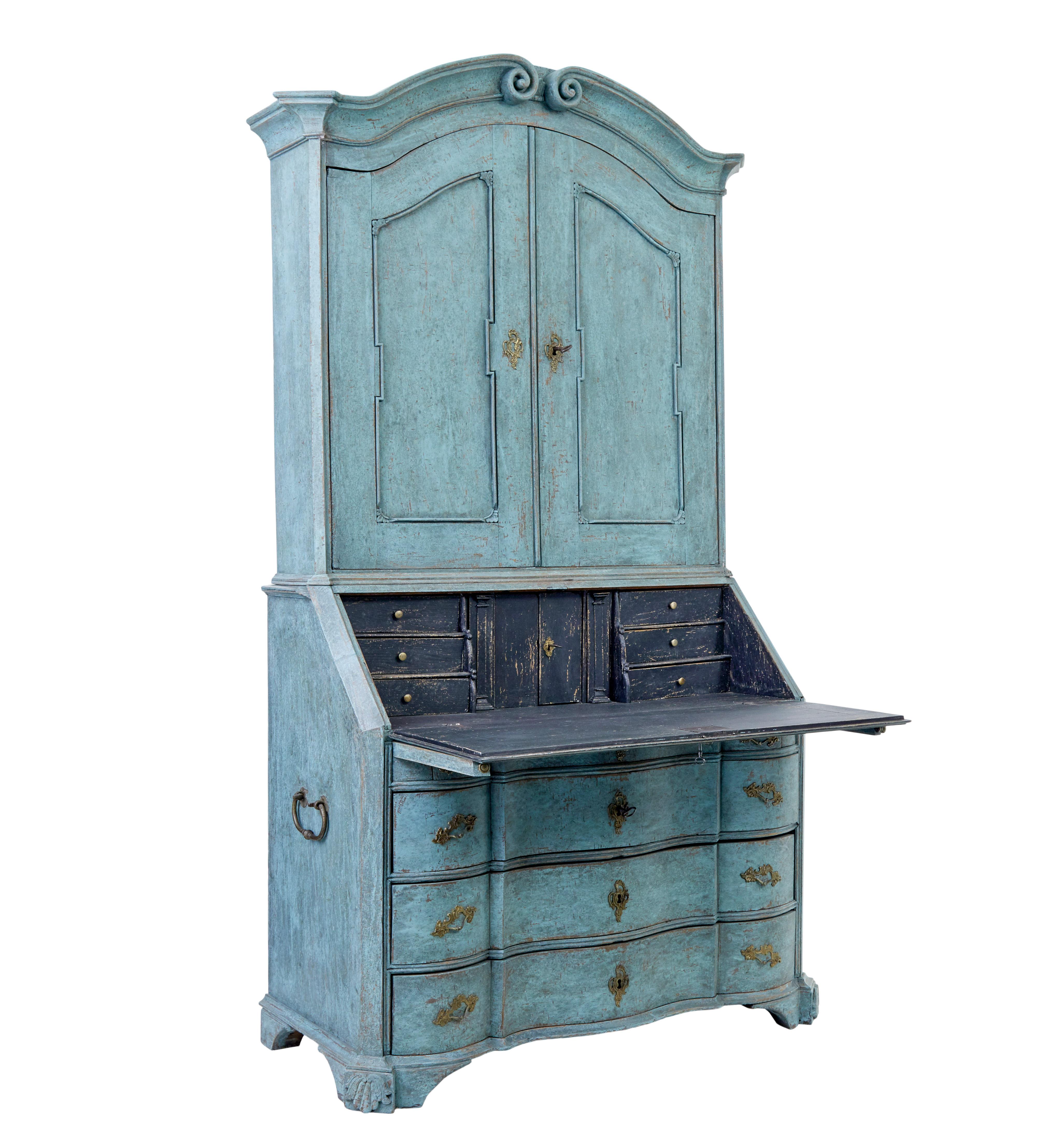 Stunning baroque Swedish painted bureau bookcase circa 1780.

Comprising of 2 parts.  Top section with a beautiful deep scrolling cornice, below which the double doors open to 3 shelves.  Bottom section with moulded bureau front, fall opens to