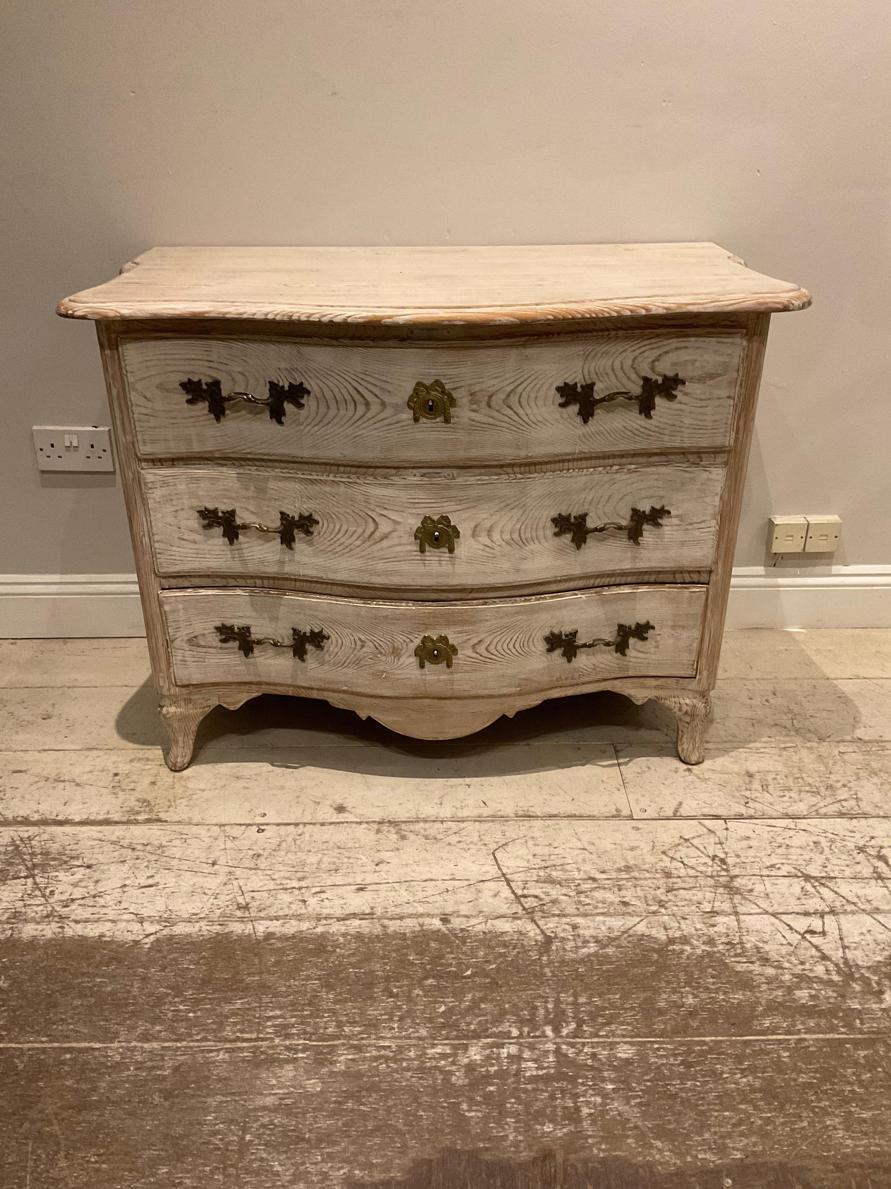  Late C18th Swedish oak commode/chest of drawers. 
The wood has been lightened to  show off its beautiful and highly decorative grain. 

The commode has a serpentine shaped front with three useful good size drawers with original handles and
