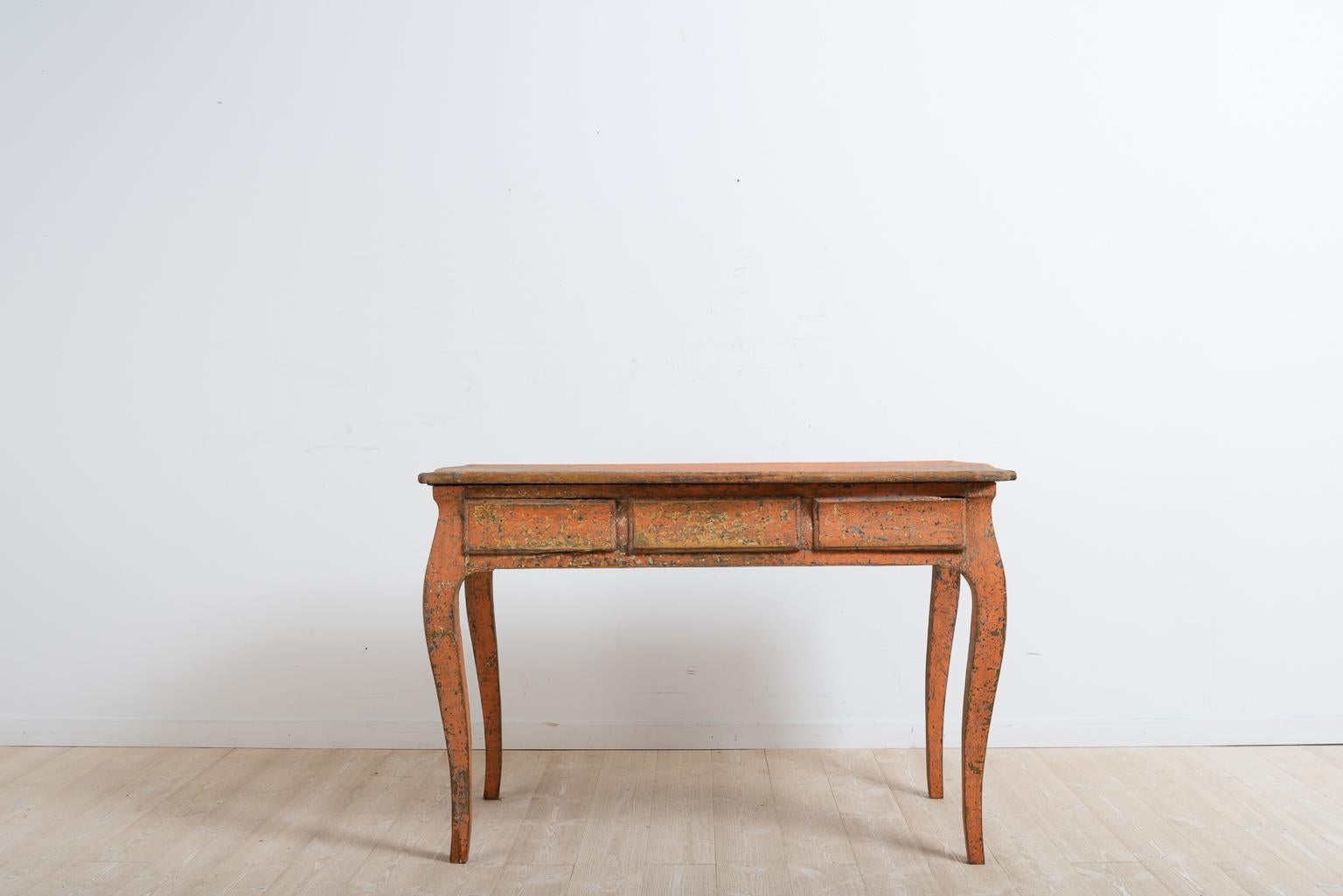 Late 18th century Rococo desk from northern Sweden. The desk has a profiled tabletop with curved rims. Dry scraped to the original first layer of paint. The drawers have signatures from previous generations and owners underneath. The desk is