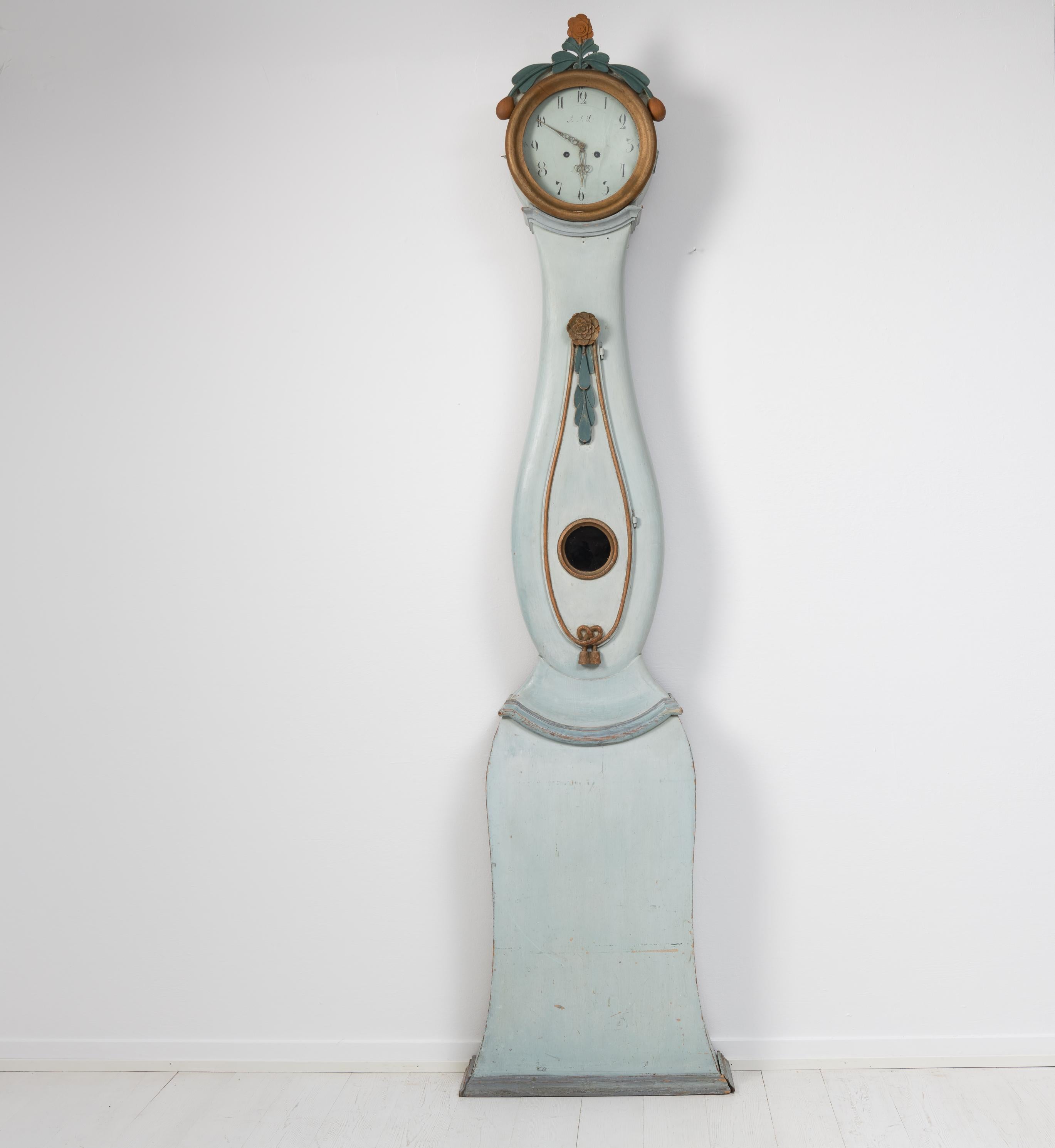 Northern Swedish rococo long case clock. The shape of the case is rococo and the expression is unique for the area Jämtland in Sweden. Made by hand during the late 1700s in pine with hand carved decor. A long case clock is one of the most iconic