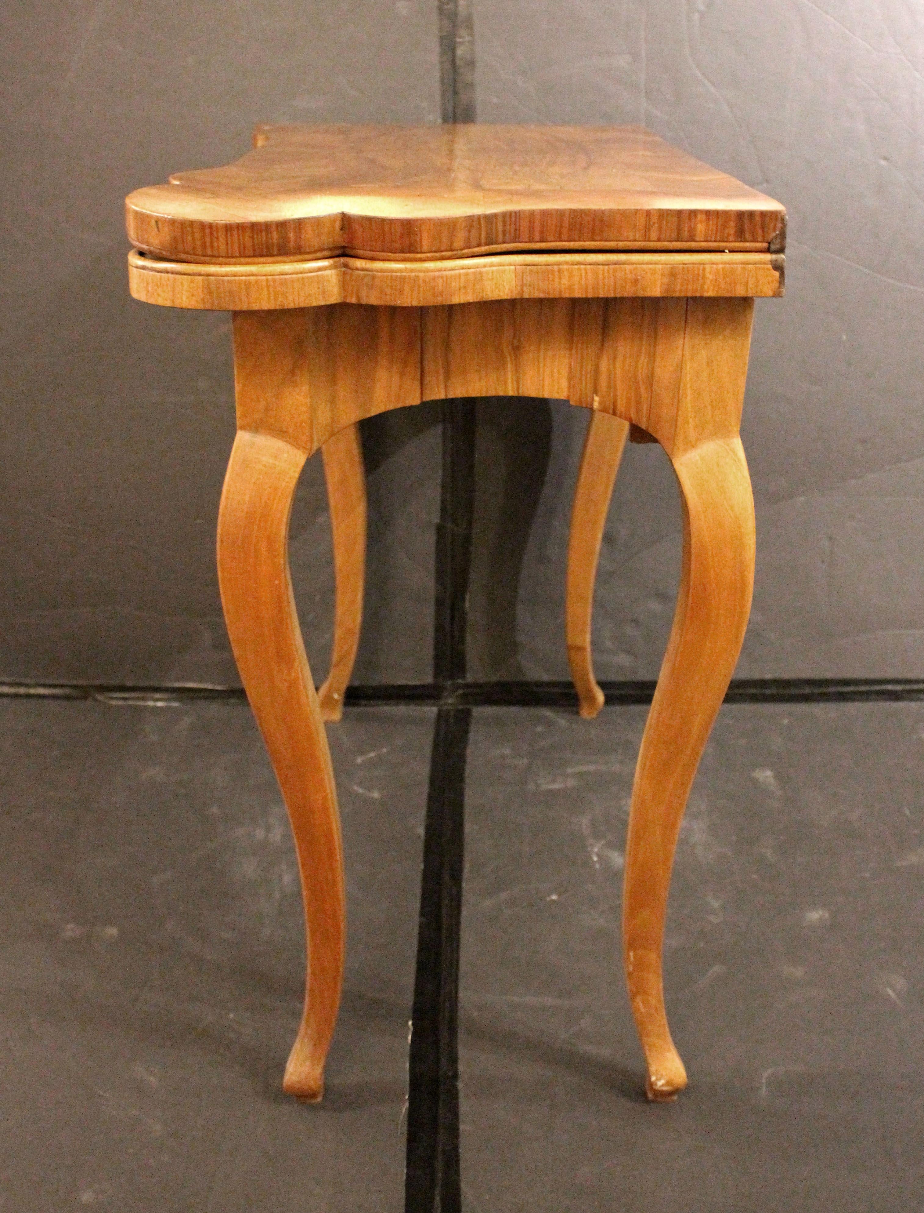 Late 18th century Swiss or German games table. Elegant form. Concertina action, ideal for seating while in use. Candle wells. Walnut. Quartered veneer panel with wide herringbone band. Vertically veneered apron. Graceful cabriole legs of figured