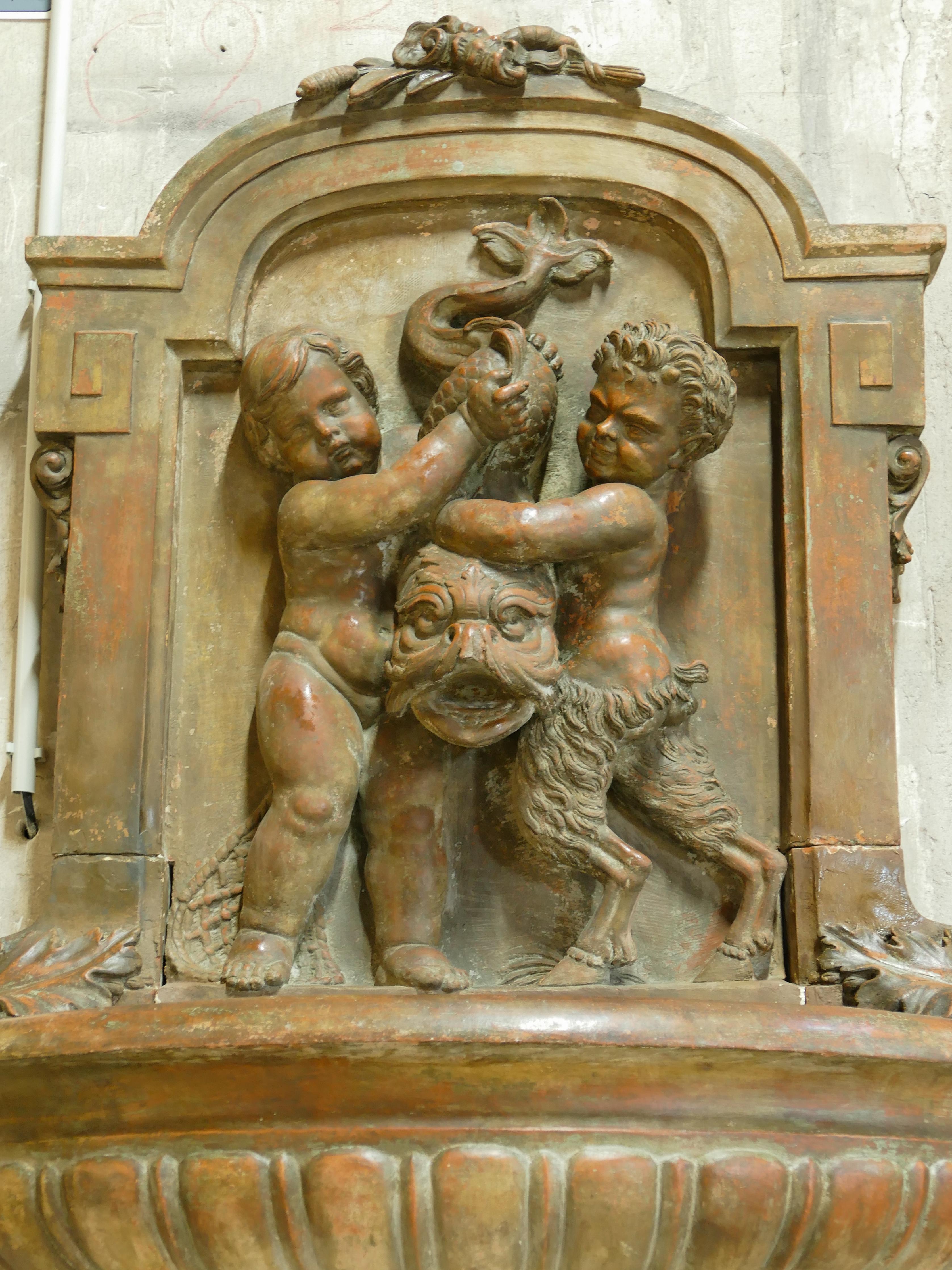 Late 18th century terracotta decorative fountain with sculptures of a child and faun 