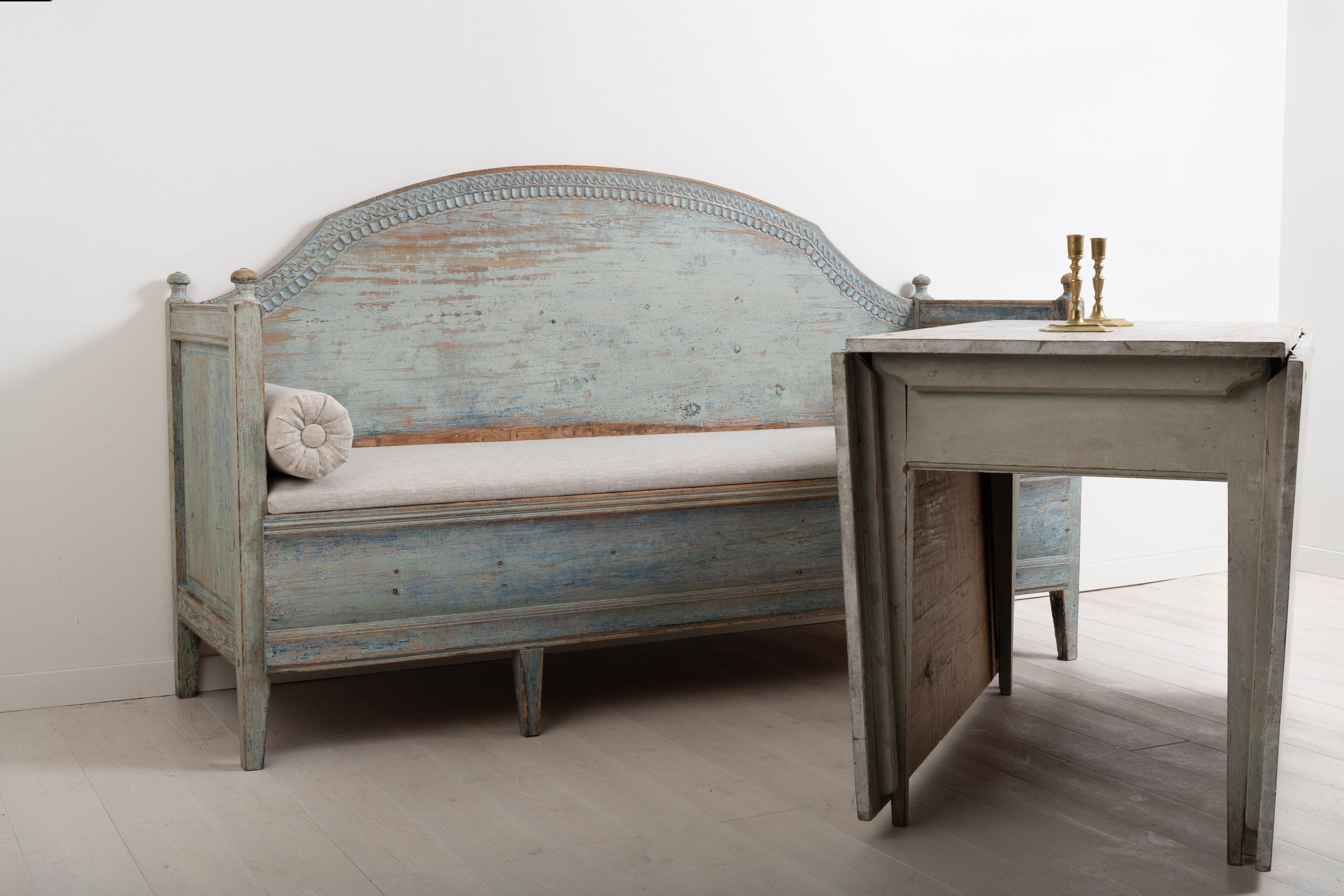 Late 18th century unusual Gustavian sofa from northern Sweden. The sofa has a straight model with a curved back and decorations carved to look like leafs. Good patina. Dry scarped to the original blue paint. The seat is later, likely from the 1800s