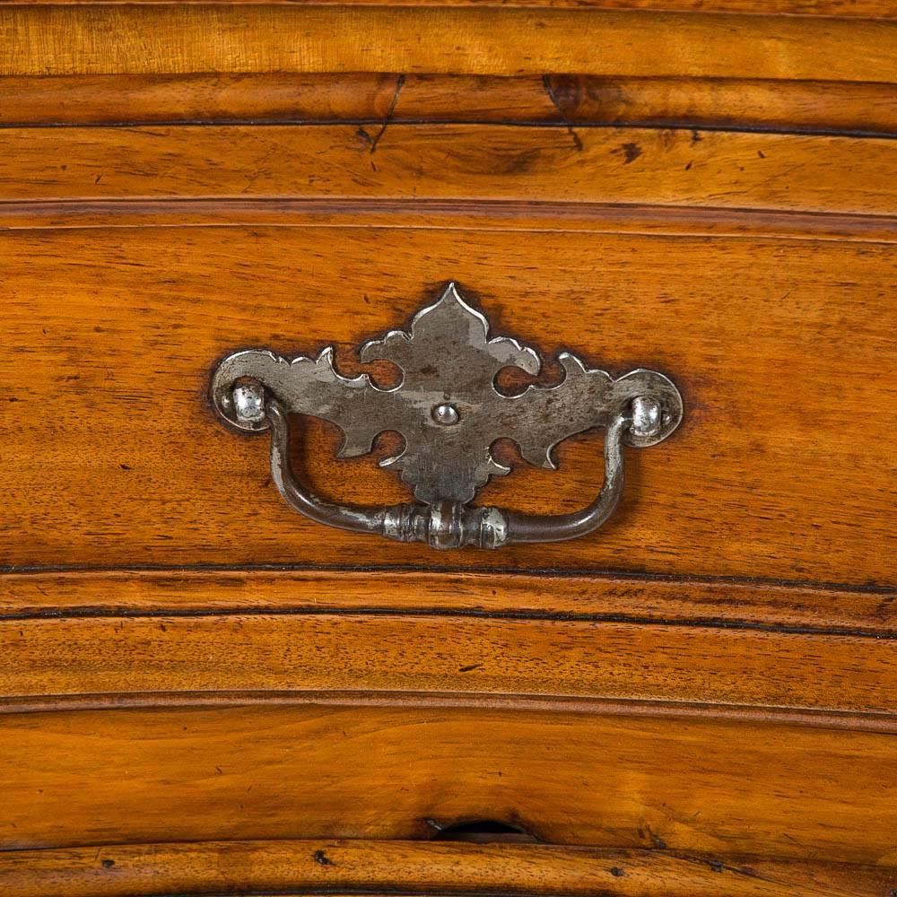 A late 18th century three drawer walnut bombé commode, with steel handles and escutcheons.

Probably made in the Bordeaux region of south-western France.

 