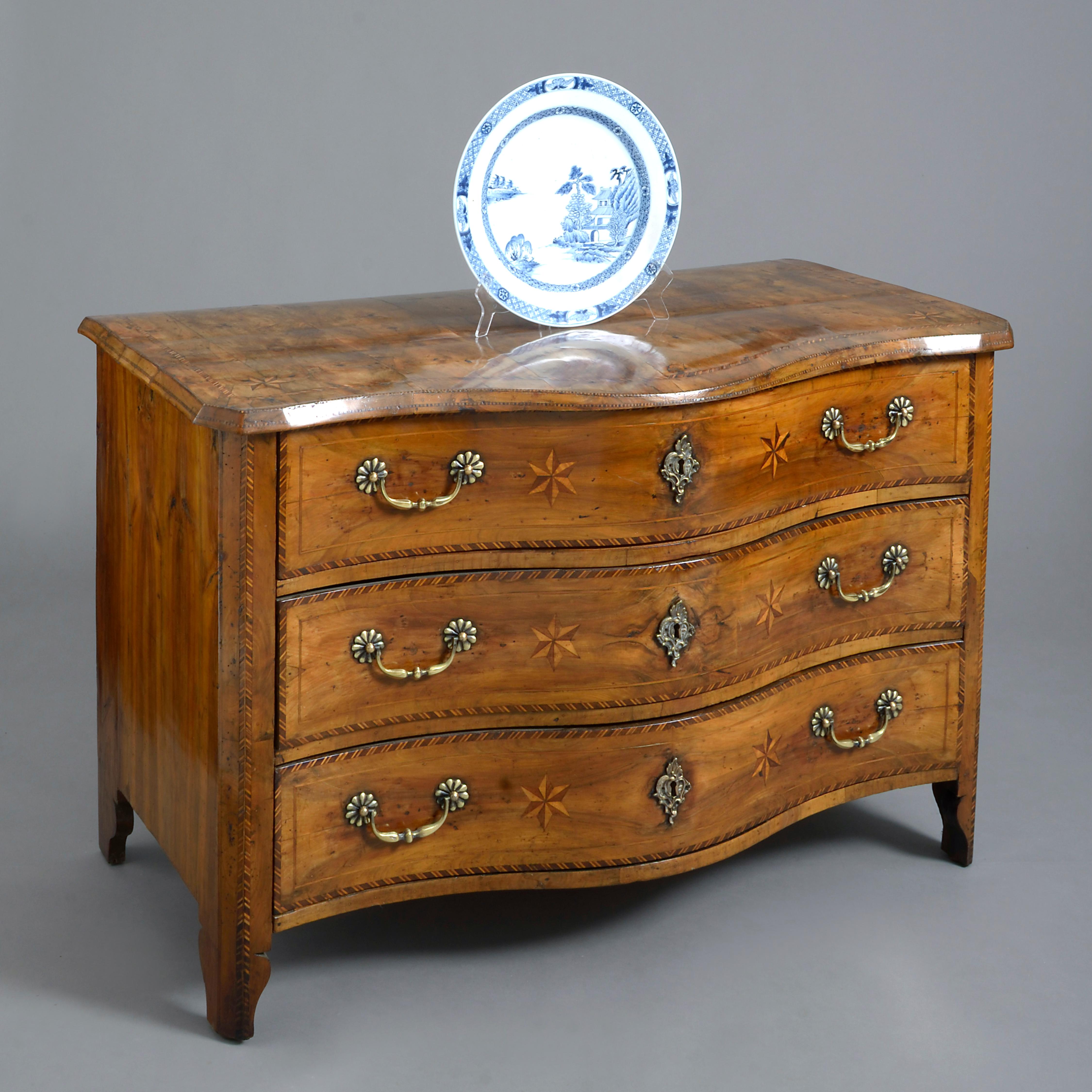 A fine late 18th century walnut commode of serpentine form and exceptional colour, the top and three drawers with parquetry inlay of stringing and stars, having brass handles and lock escutcheons and all raised upon bracket feet.