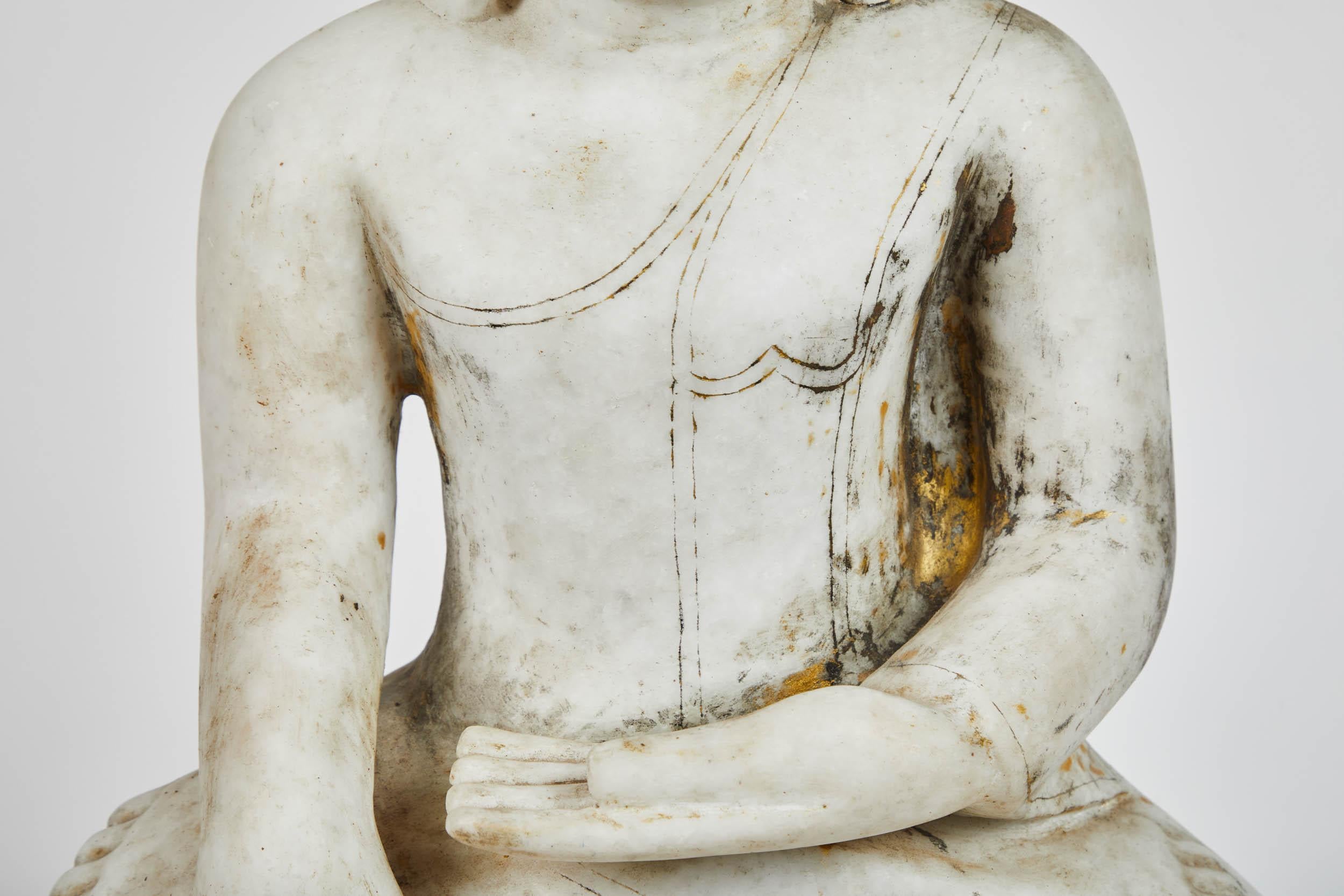 18th century Ava style Buddha from Central Myanmar in white alabaster. Carved detailing around base, but otherwise simple form.