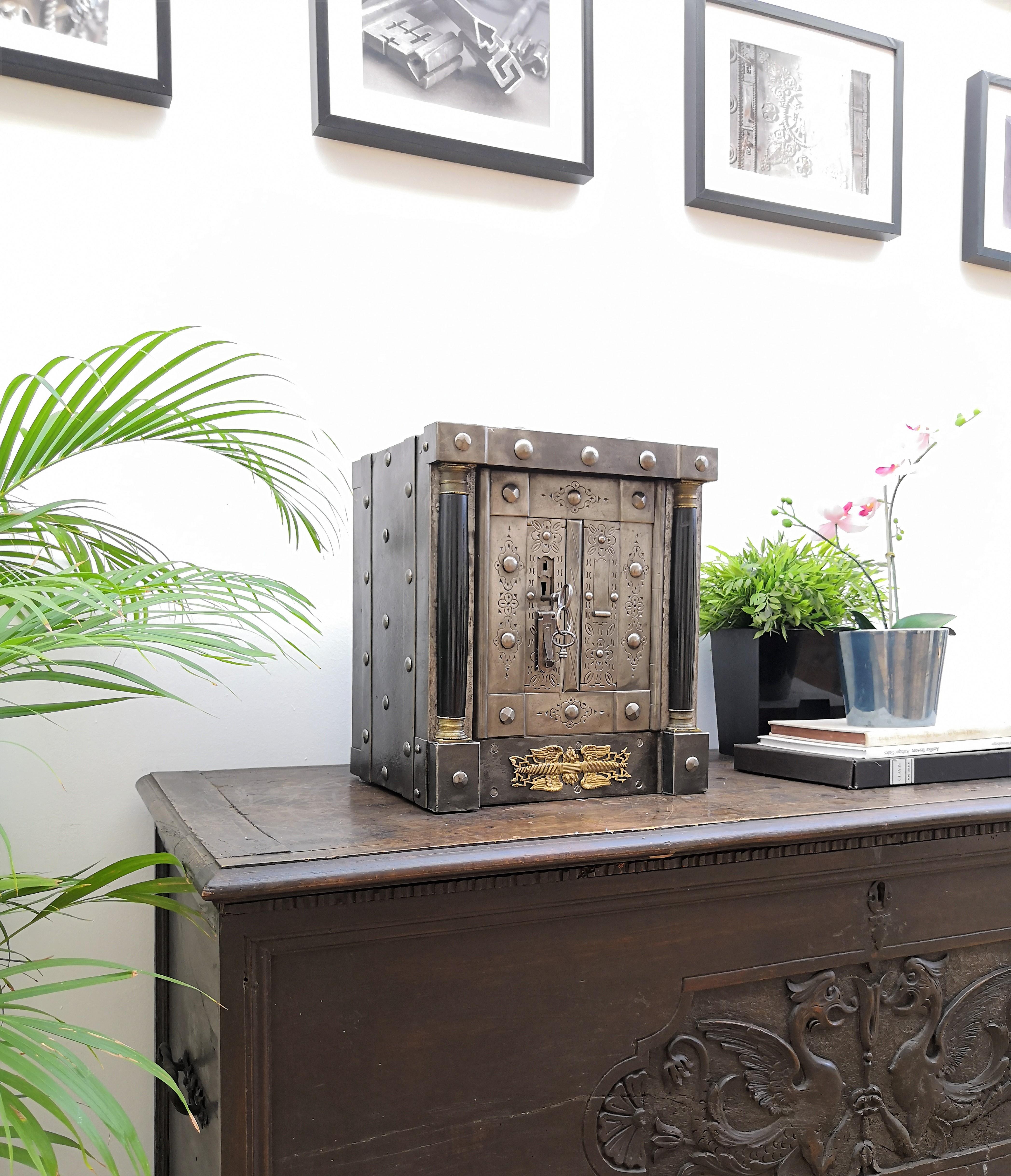 Northern Italian antique safe with all-around hobnails, dated circa 1790-1820, probably from the Piedmont region that features amazing Empire-style columns with golden details and decorations as well as beautiful burin incisions, a typical handmade