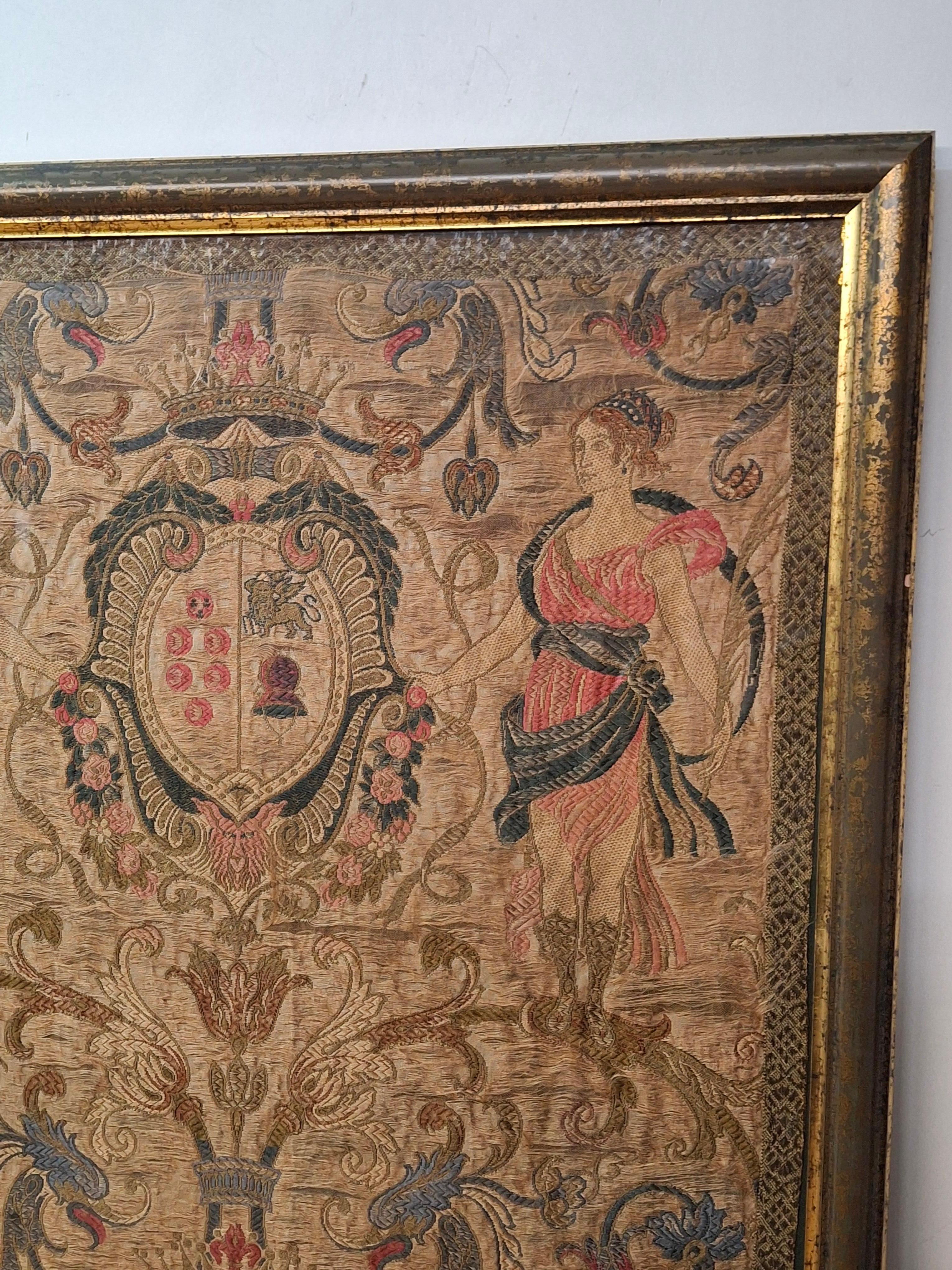 Late 18th- early 19th century framed silk embroidered tapestry in a stunning blend of intricate design and rich colors that will enhance any decor. This unique piece features a captivating motif, showcasing beautifully detailed figures intertwined