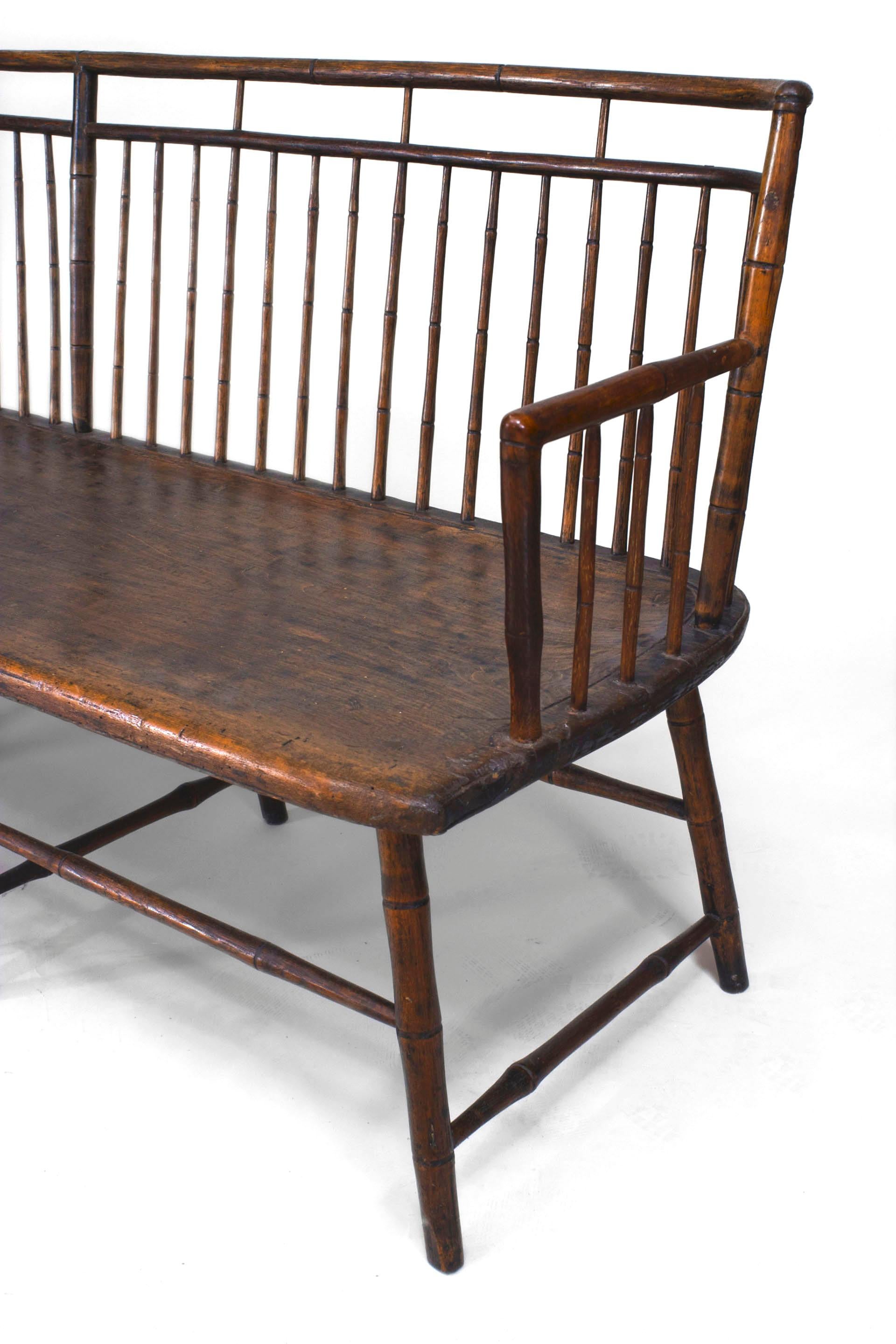 Late 18th-early 19th century American Pennsylvanian pine Windsor style settee with an oak faux bamboo turned spindle back with rounded corners and a birdcage stretcher (originally painted).
