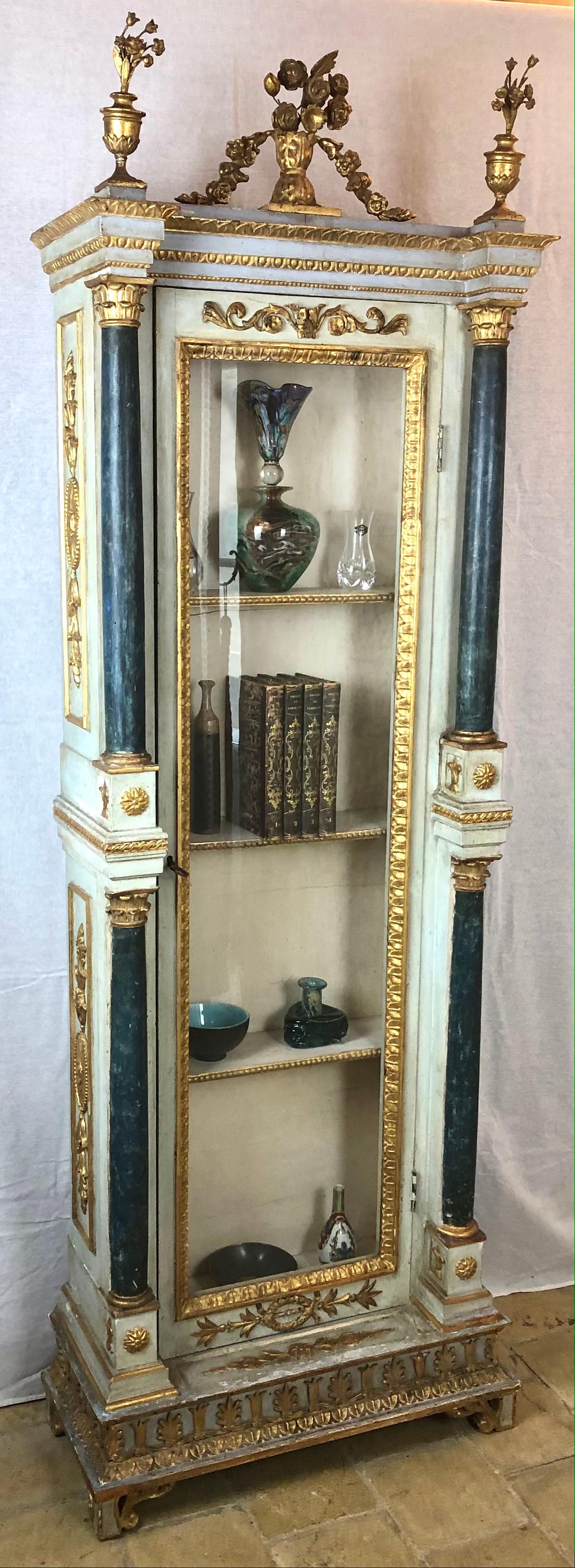 An exquisite Venetian cabinet with remarkable Rococo period details. 
Gilt wood and painted in a very appealing and eye catching colors. 

This ornate Italian cabinet is decorated with hand-carved details and hand-painted throughout. It has