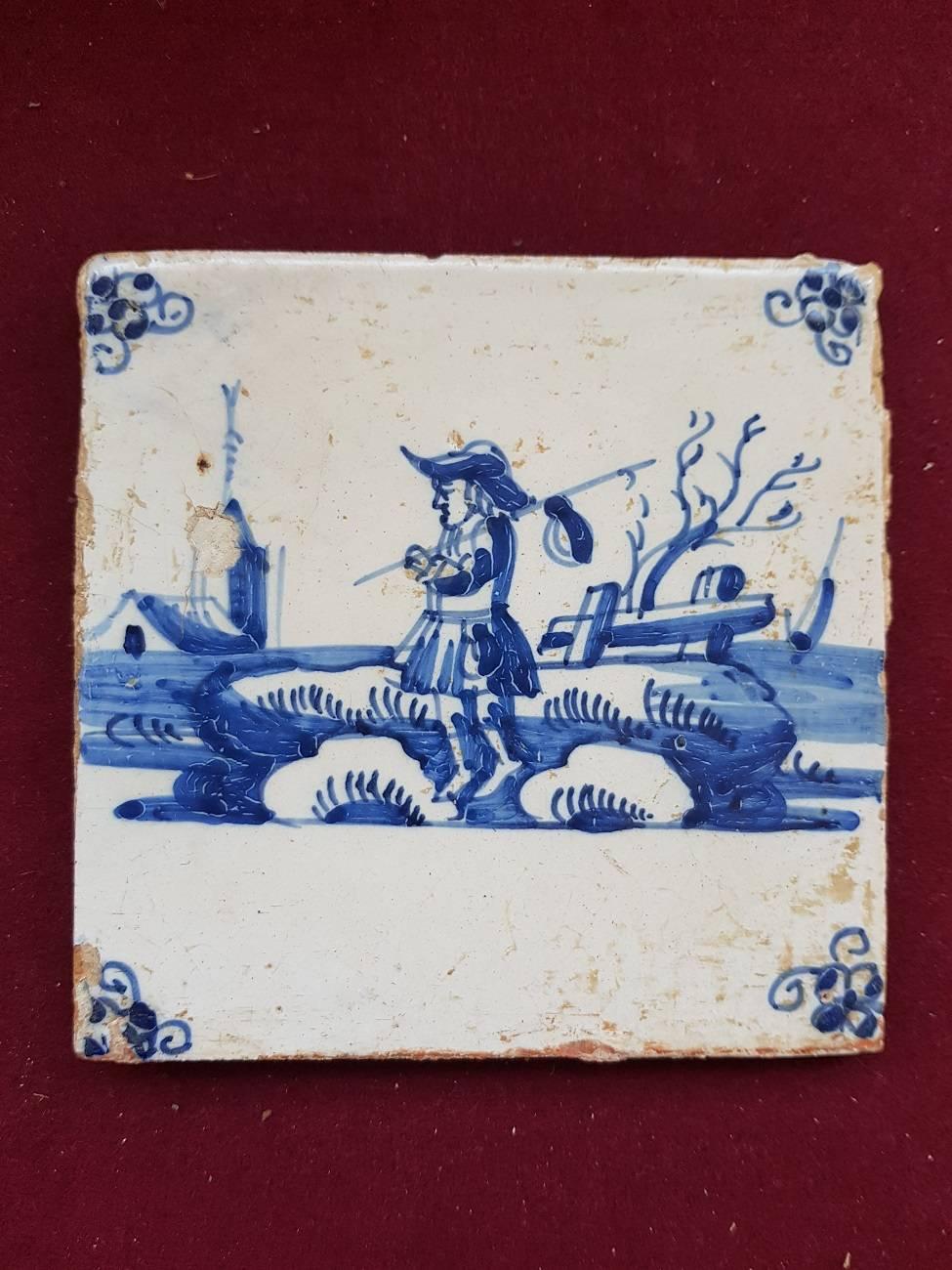 Late 18th early-19th century Delft blue tile with a hand painted scene of a person in open countryside,

The measurements are:
Depth 8 mm/ 0.3 inch.
Width 13 cm/ 5.1 inch.
Height 13 cm/ 5.1 inch.