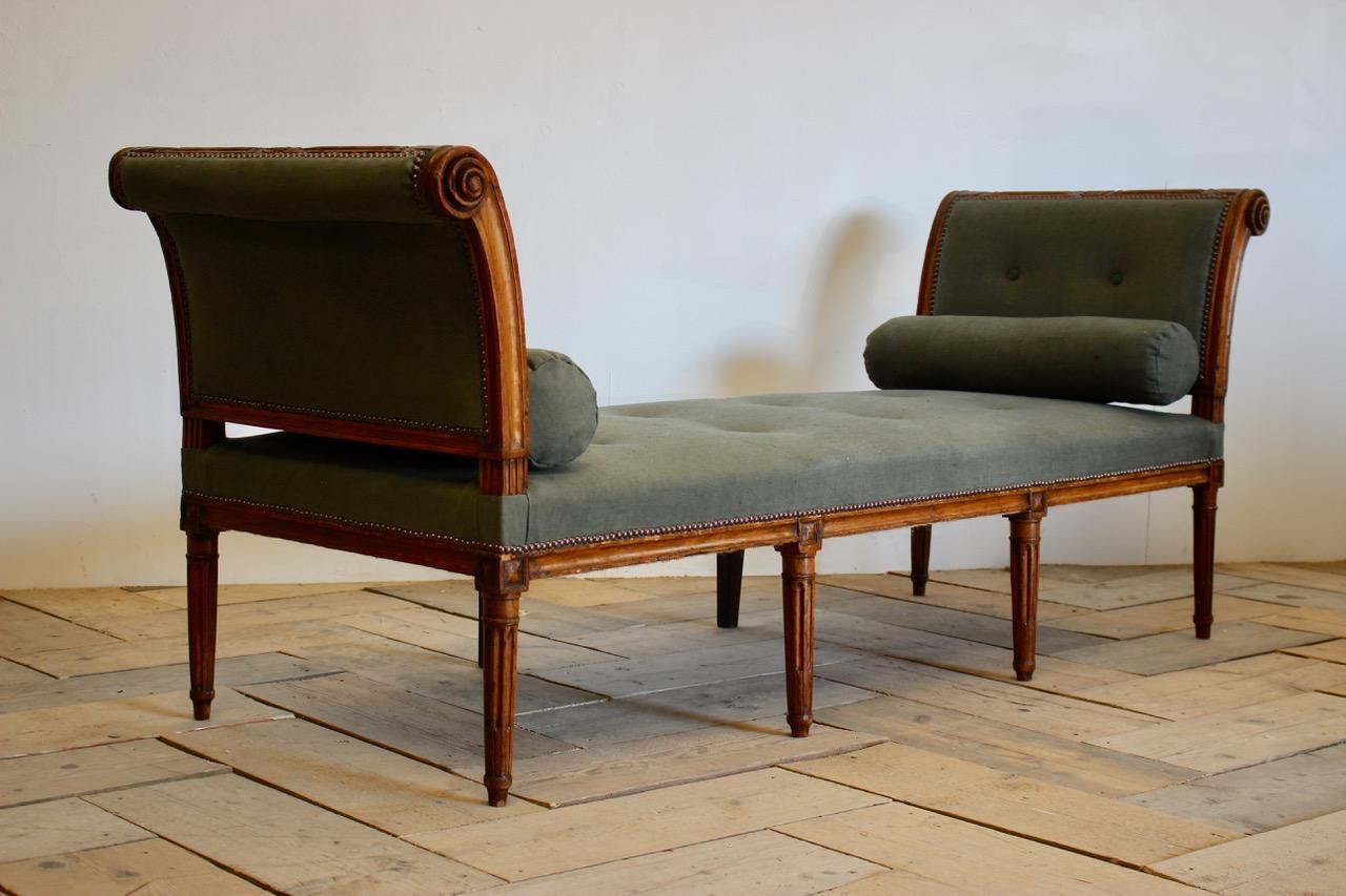 A fine quality and with a lovely color, late 18th-early 19th century French walnut daybed / window seat with good detail, on eight legs, having been reupholstered by us in an antique hand dyed linen with studs.
The elegant design of this daybed