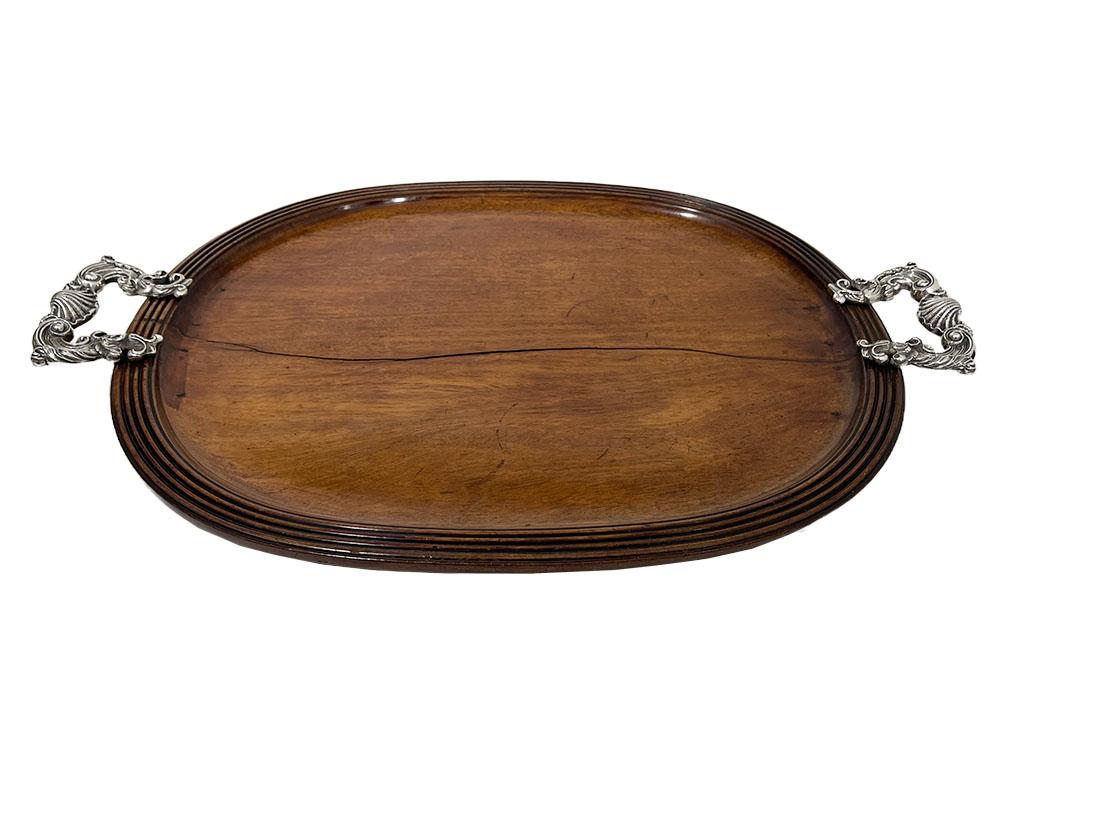 Late 18th/ early 19th century French wooden serving tray with Rocaille handles

A beautiful oval wooden tray with Rocaille handles from the late 18th century, early 19th century. The tray has been restored in the 19th century and 1 handle has new