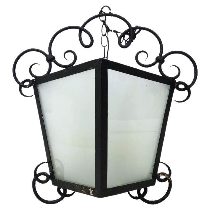Late 18th early 19th century French lanterns made of wrought iron with curled metal details and opaque class panels.

Property from esteemed interior designer Juan Montoya. Juan Montoya is one of the most acclaimed and prolific interior designers