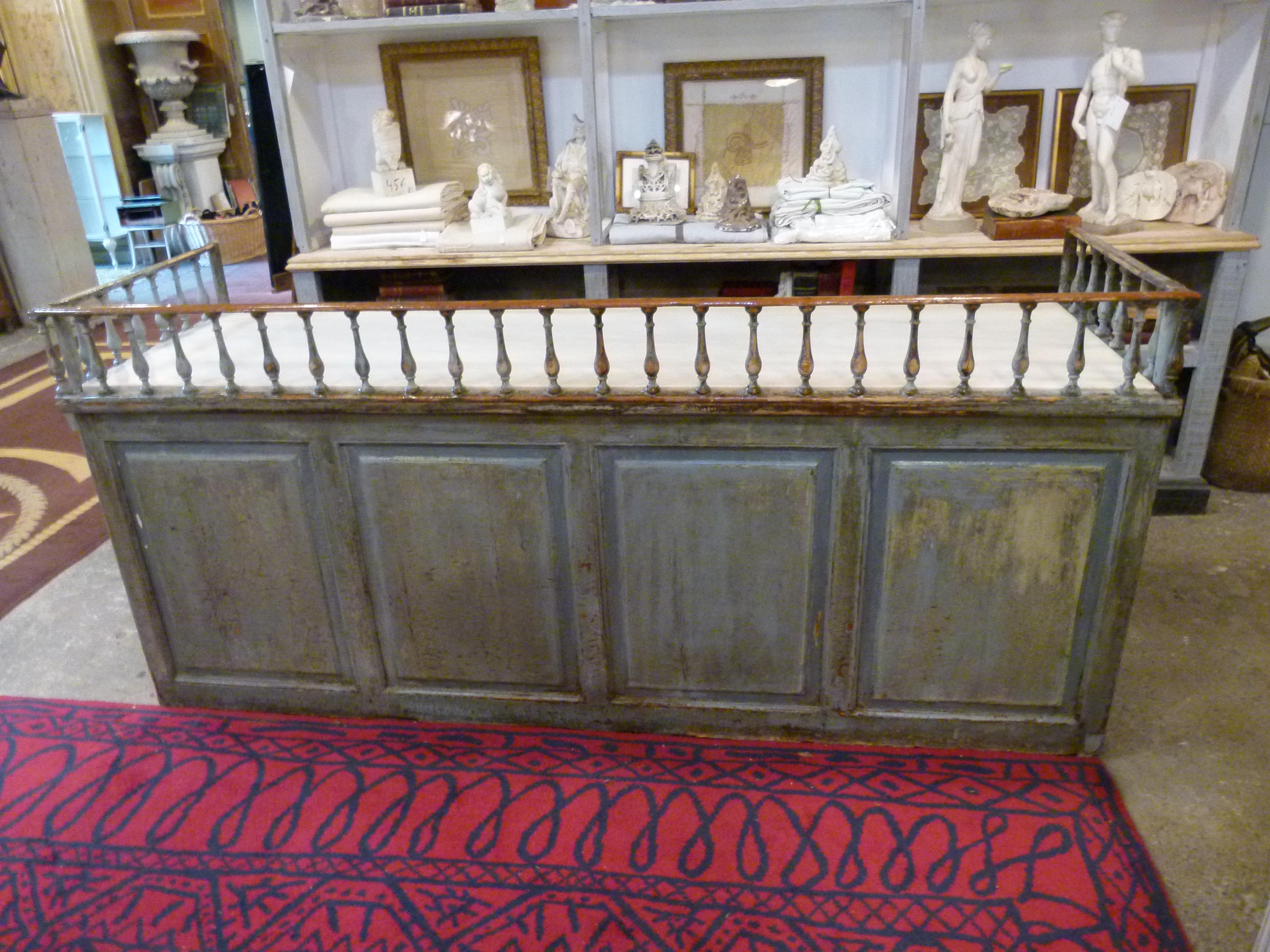 Late 18th-early 19th century hard wood bar counter with a grey /blue patina. The marble top is surrounded by a low wooden hand carved rail.

   